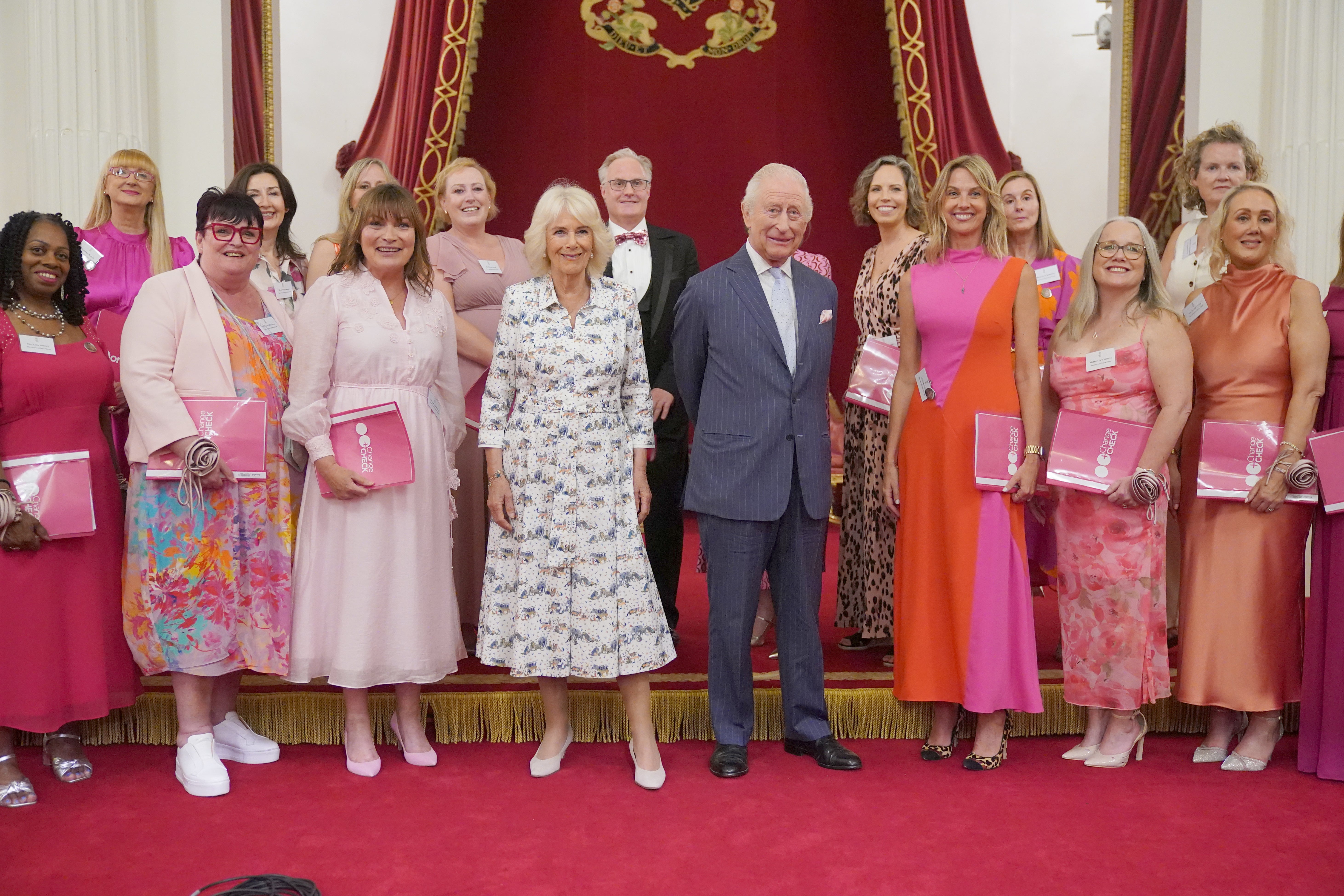 Charles and Camilla pose for a photo with Lorraine Kelly and members of the Change + Check Choir during a reception in Buckingham Palace on Wednesday