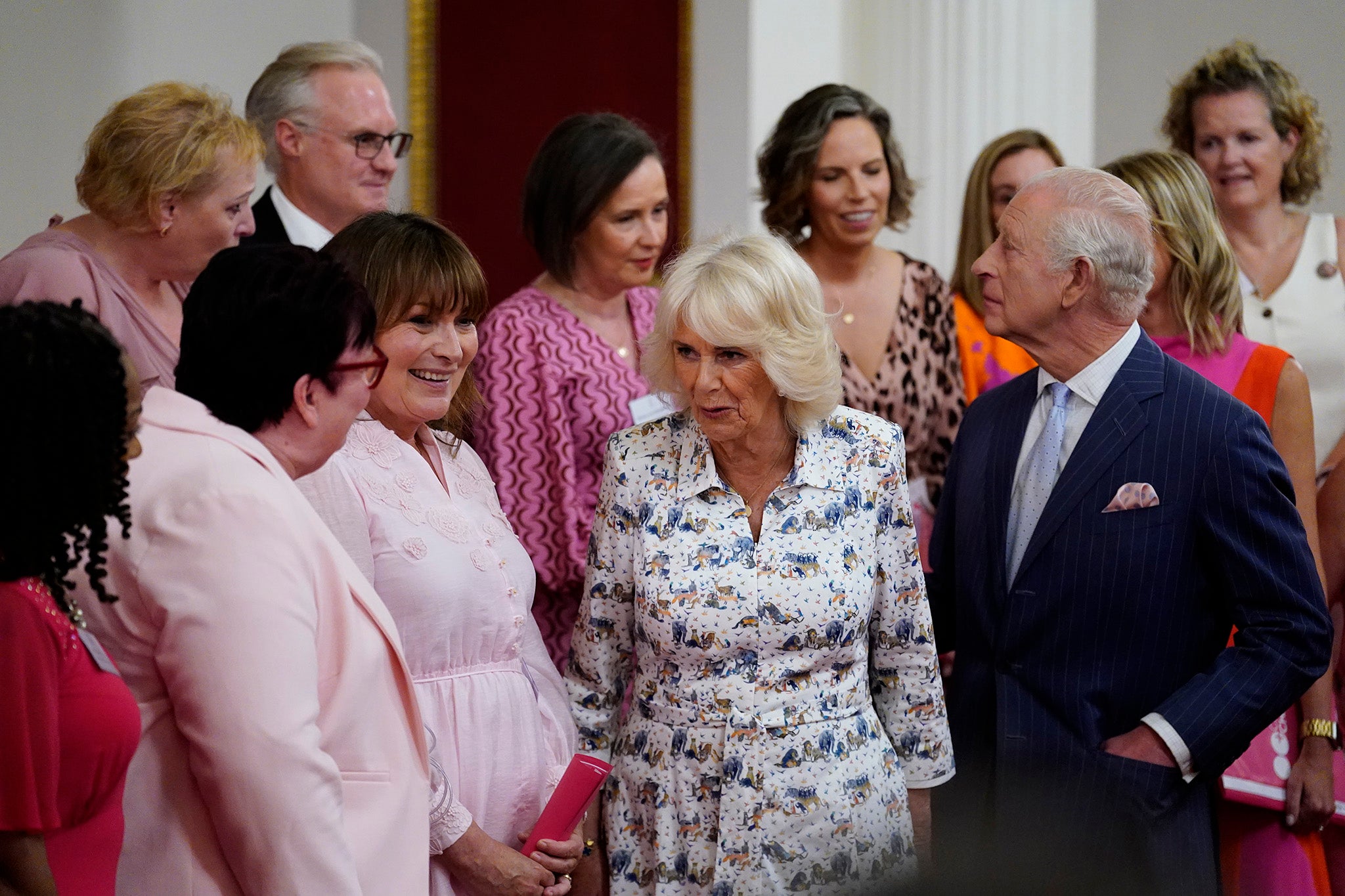 Charles and Camilla speak with presenter Lorraine Kelly (second left) and the members of the Change + Check Choir during a reception in Buckingham Palace on Wednesday