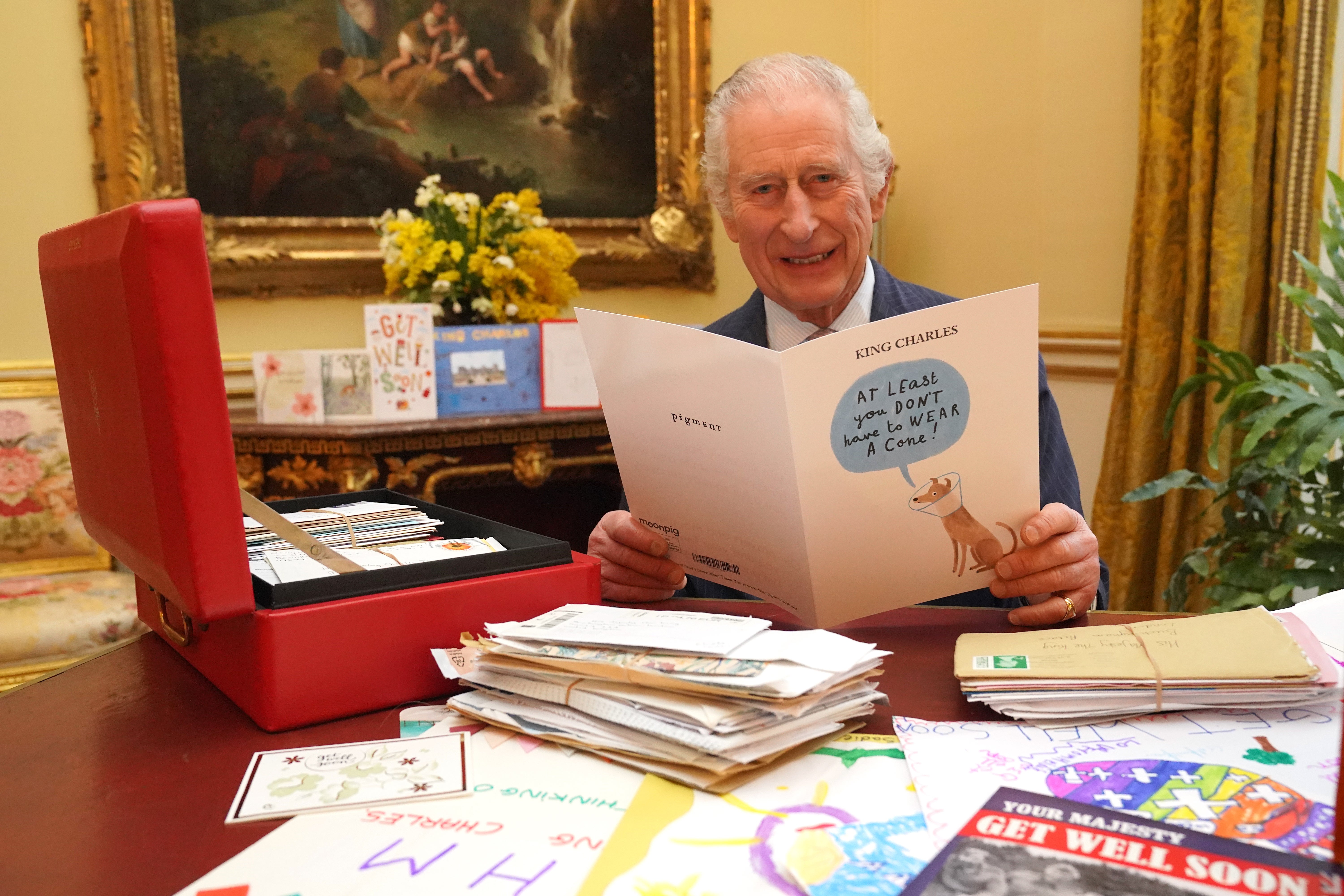 Charles reading cards and messages sent by well-wishers following his cancer diagnosis