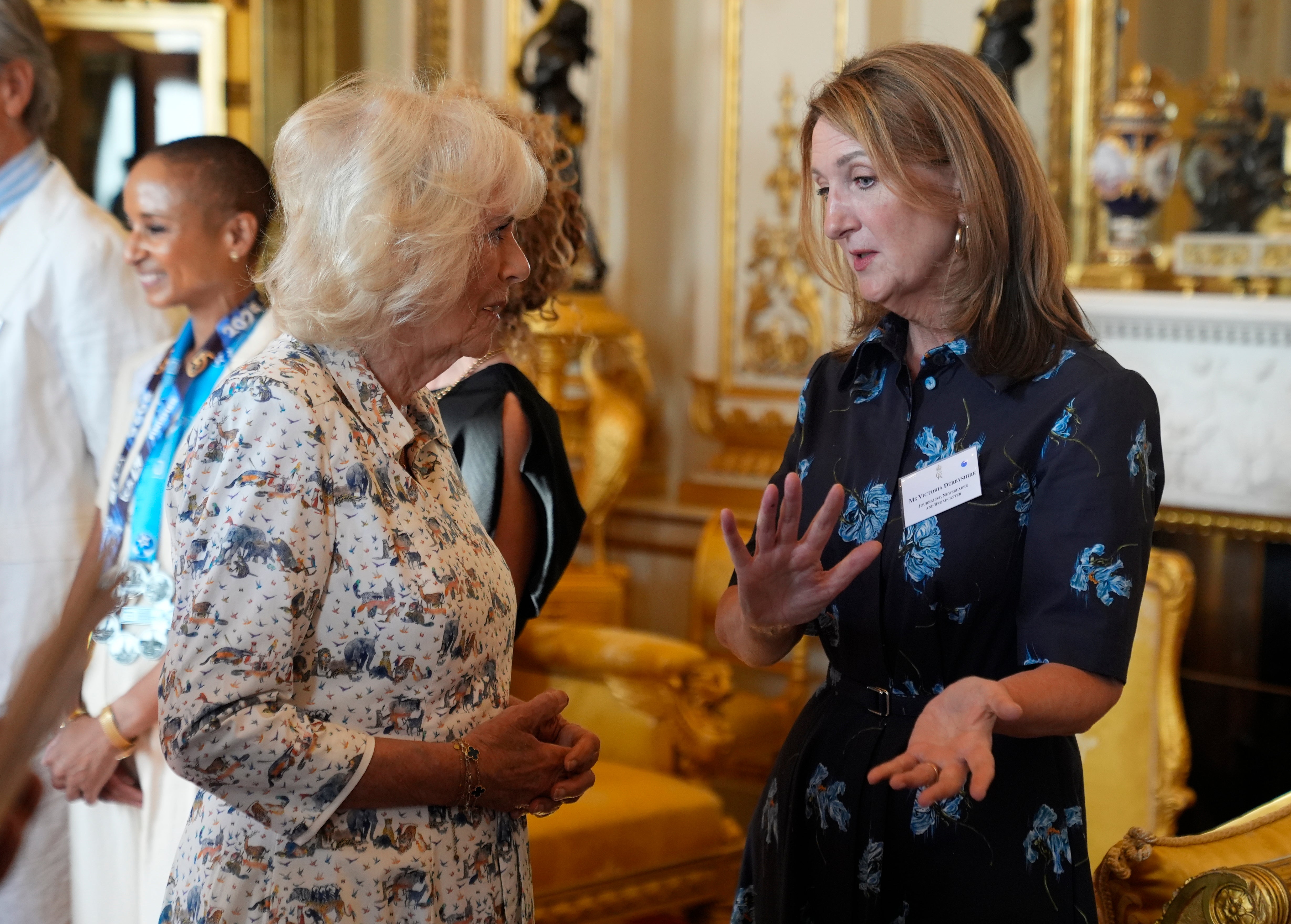 Queen Camilla speaks with Victoria Derbyshire during a reception in Buckingham Palace
