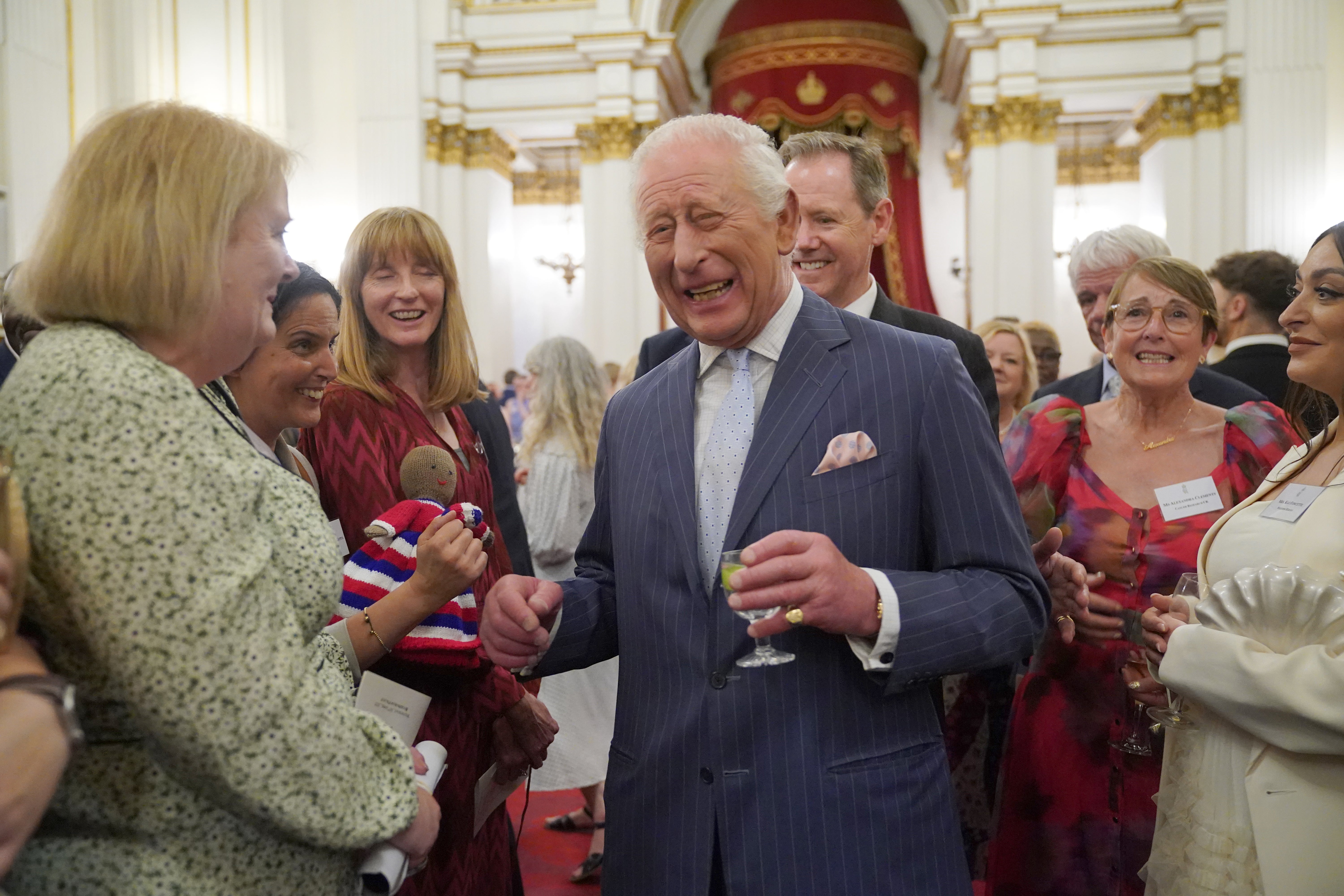 King Charles speaks to guests during a reception in Buckingham Palace