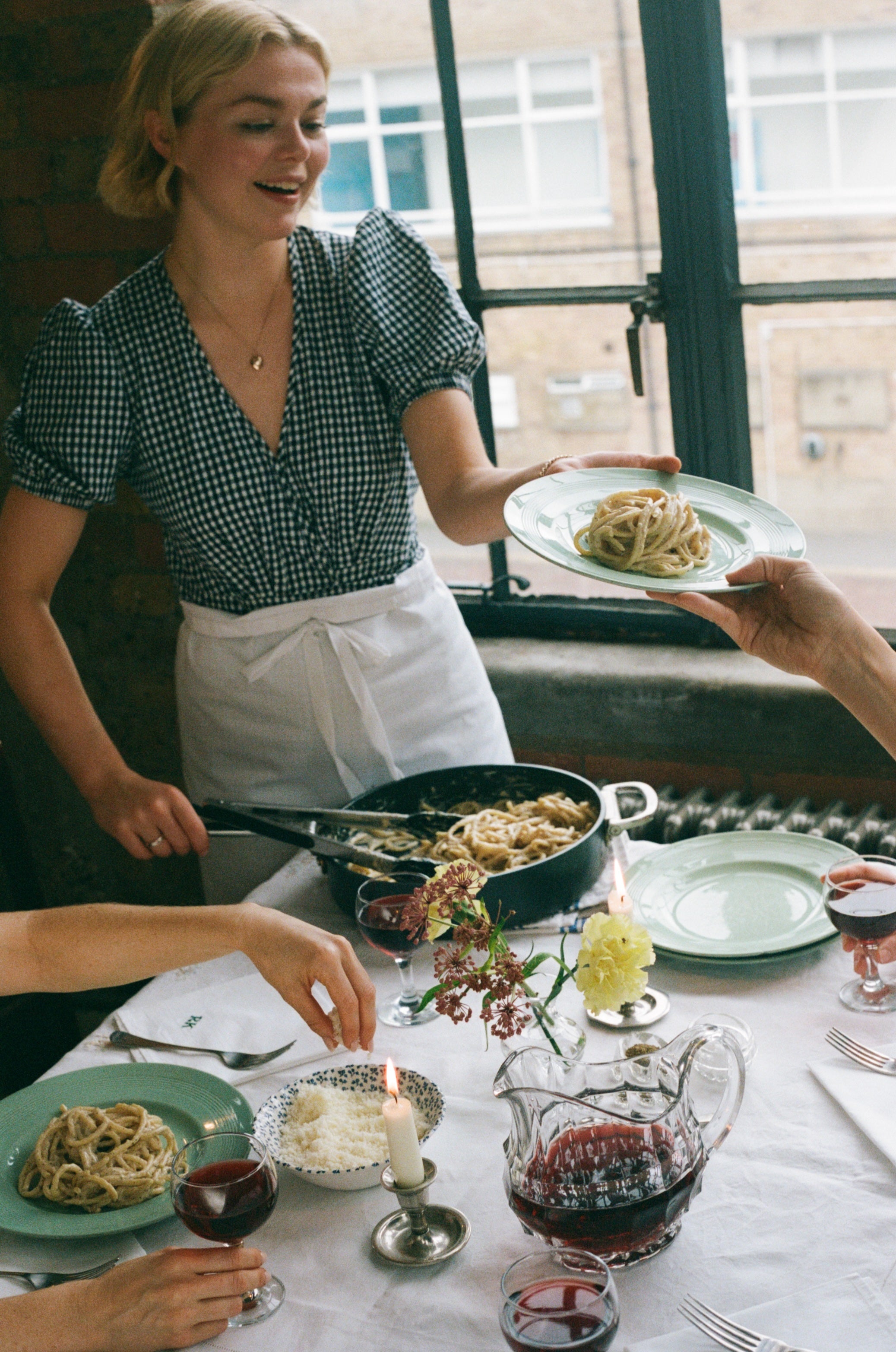 Dinner’s on: Kellett dishes up a crowd-pleasing classic, one of the many weeknight meals made on rotation in the shared kitchen