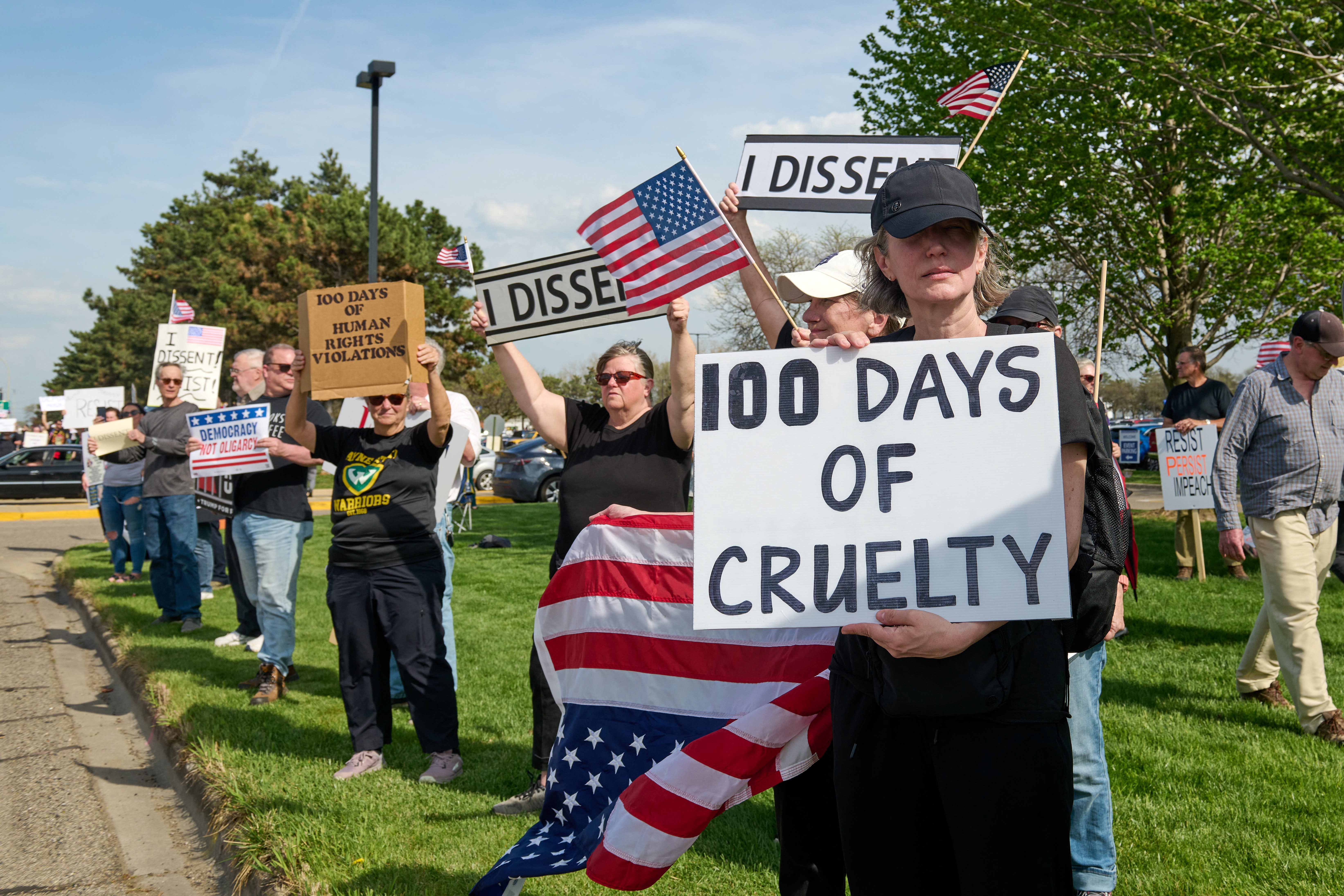 Protesters voice their anger outside the Michigan building holding Trump’s 100th-day rally