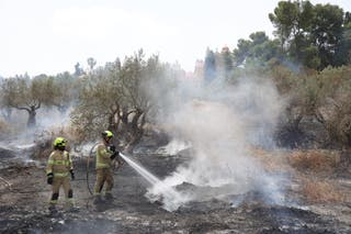 Israeli firefighters work to extinguish a fire burning near Latrun monastery on Thursday