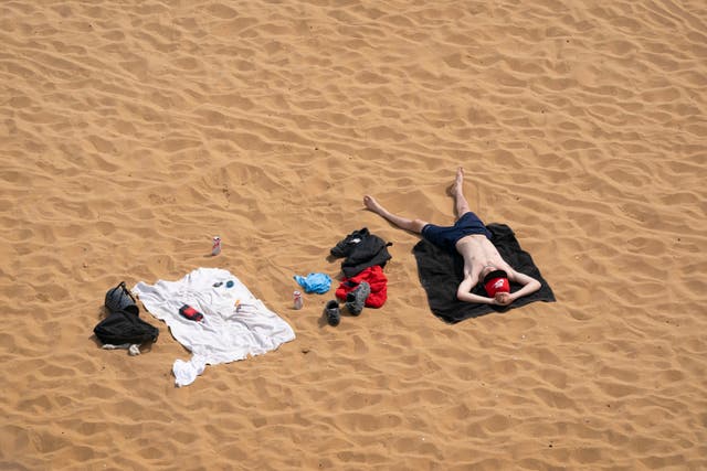 <p>A man relaxes on the beach in Broadstairs, Kent, on May 1</p>