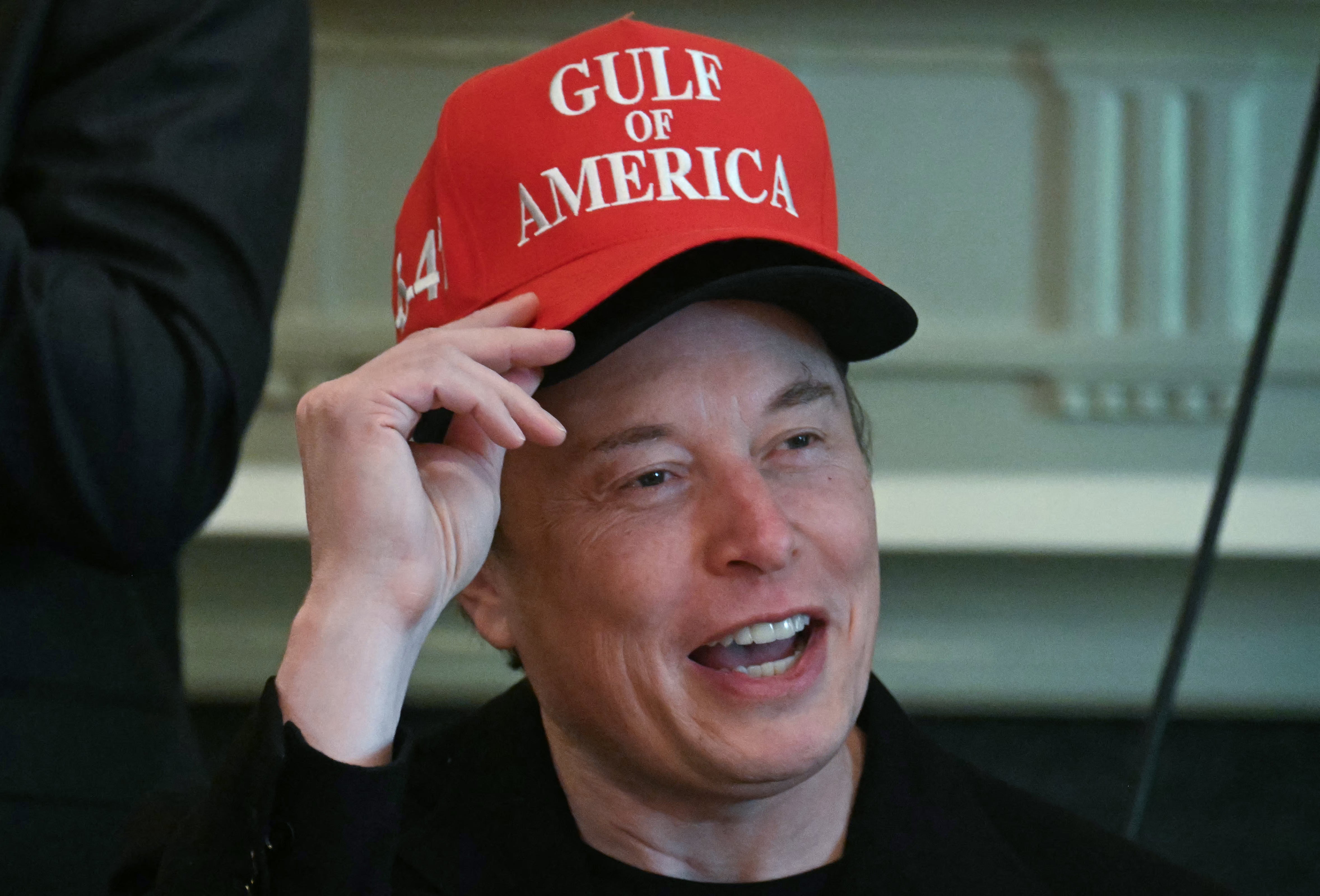 Elon Musk, wearing two hats, speaks during a cabinet meeting in the Cabinet Room of the White House in Washington, DC, on April 30, 2025. He told reporters that his time in government has been ‘60 percent fun’