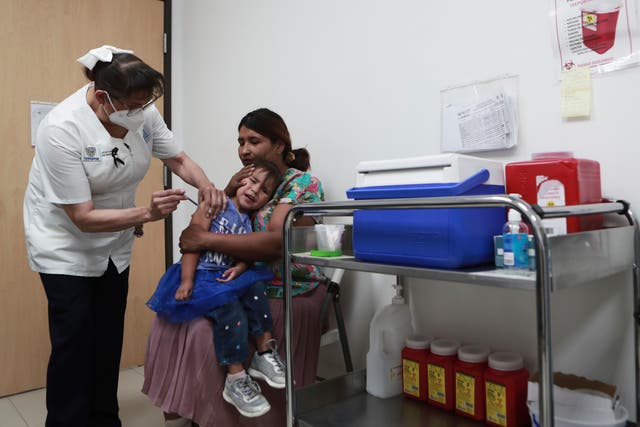 <p>A health worker gives a child a measles vaccine at the health center in Ciudad Juarez, Chihuahua state, Mexico</p>