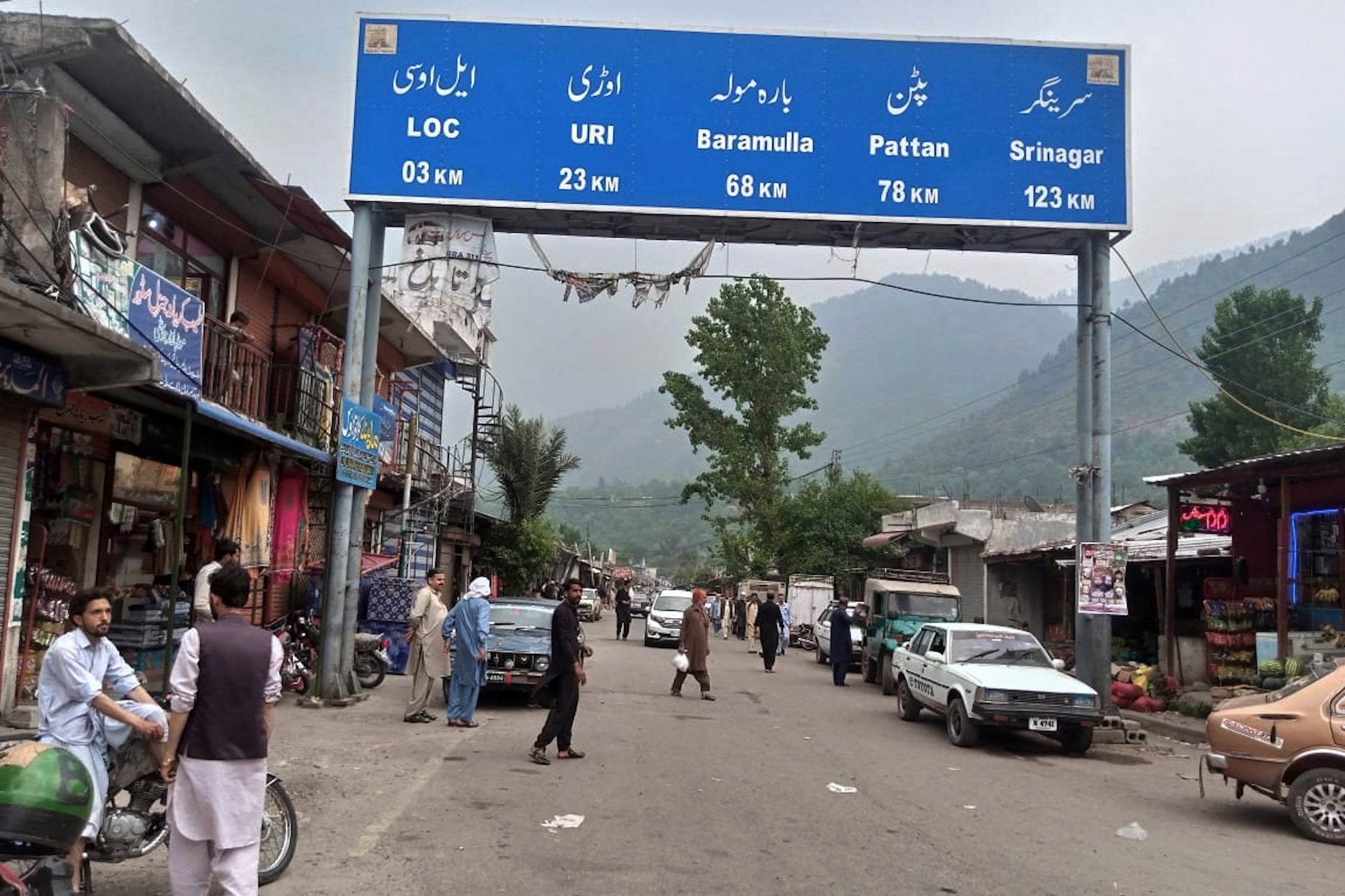 Local residents walk through the main bazaar of Chakothi, near Line of Control, the de facto border dividing Pakistan and Indian Kashmir, some 61 kilometers (38 miles) from Muzaffarabad, the capital of Pakistan controlled Kashmir, Thursday, May 1, 2025. (AP Photo/Roshan Mughal)