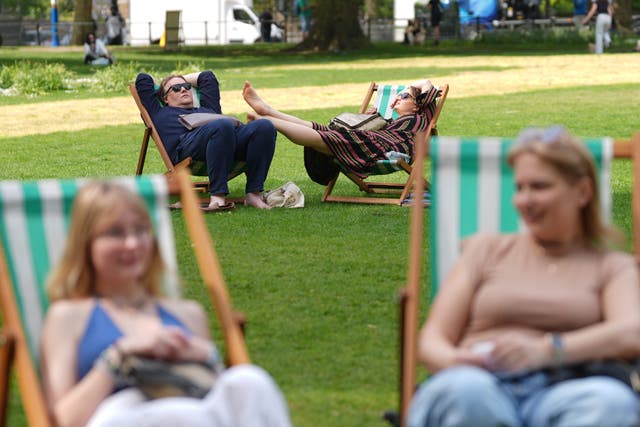 People enjoy the warm weather in St James’s Park, London (Yui Mok/PA)