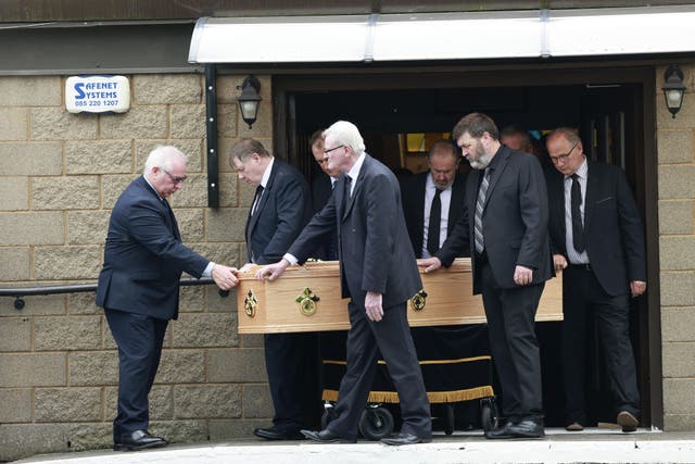 The coffin of Bishop Brendan Comiskey, who resigned over criticism of his role in investigating allegations of clerical sexual abuse, is carried out of the Church of the Sacred Heart, in Clondalkin (PA)