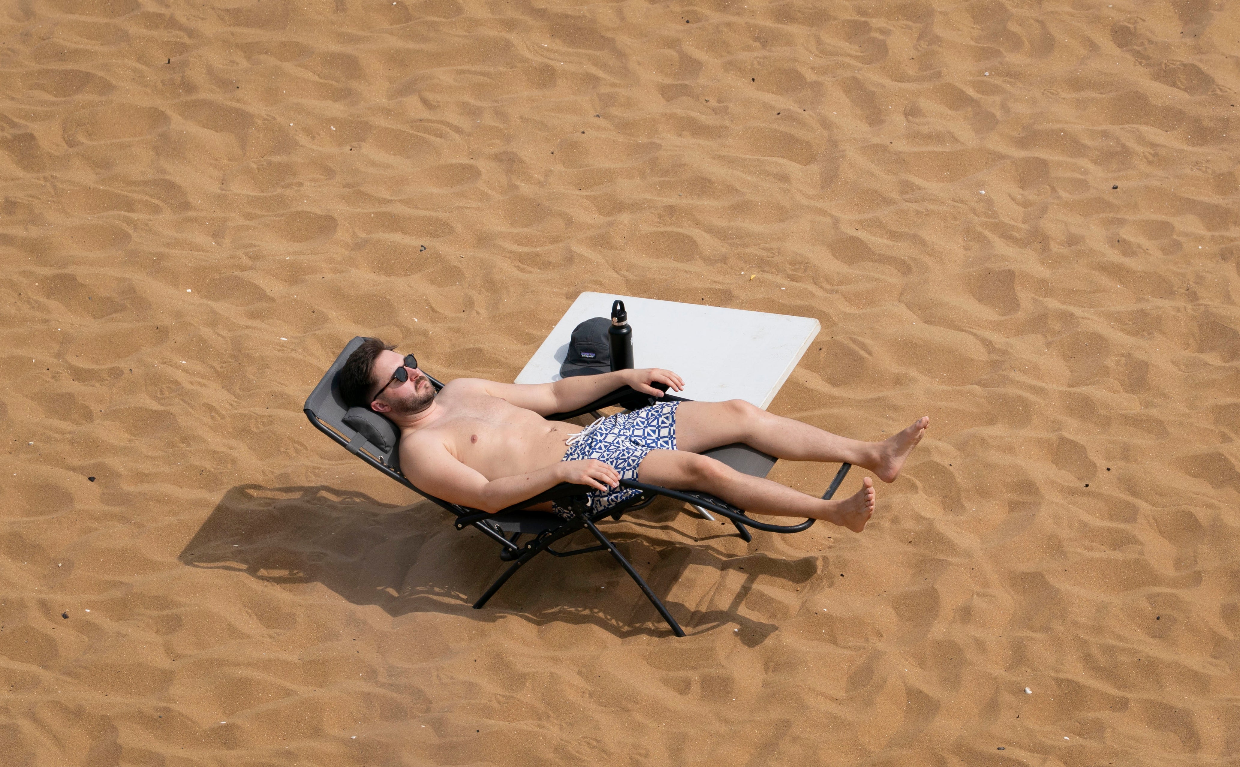 A man relaxes on the beach in Broadstairs, Kent, on Thursday