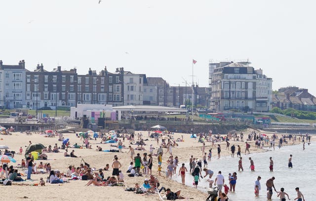 <p>People enjoy the warm weather on the beach in Margate, Kent, on Thursday</p>