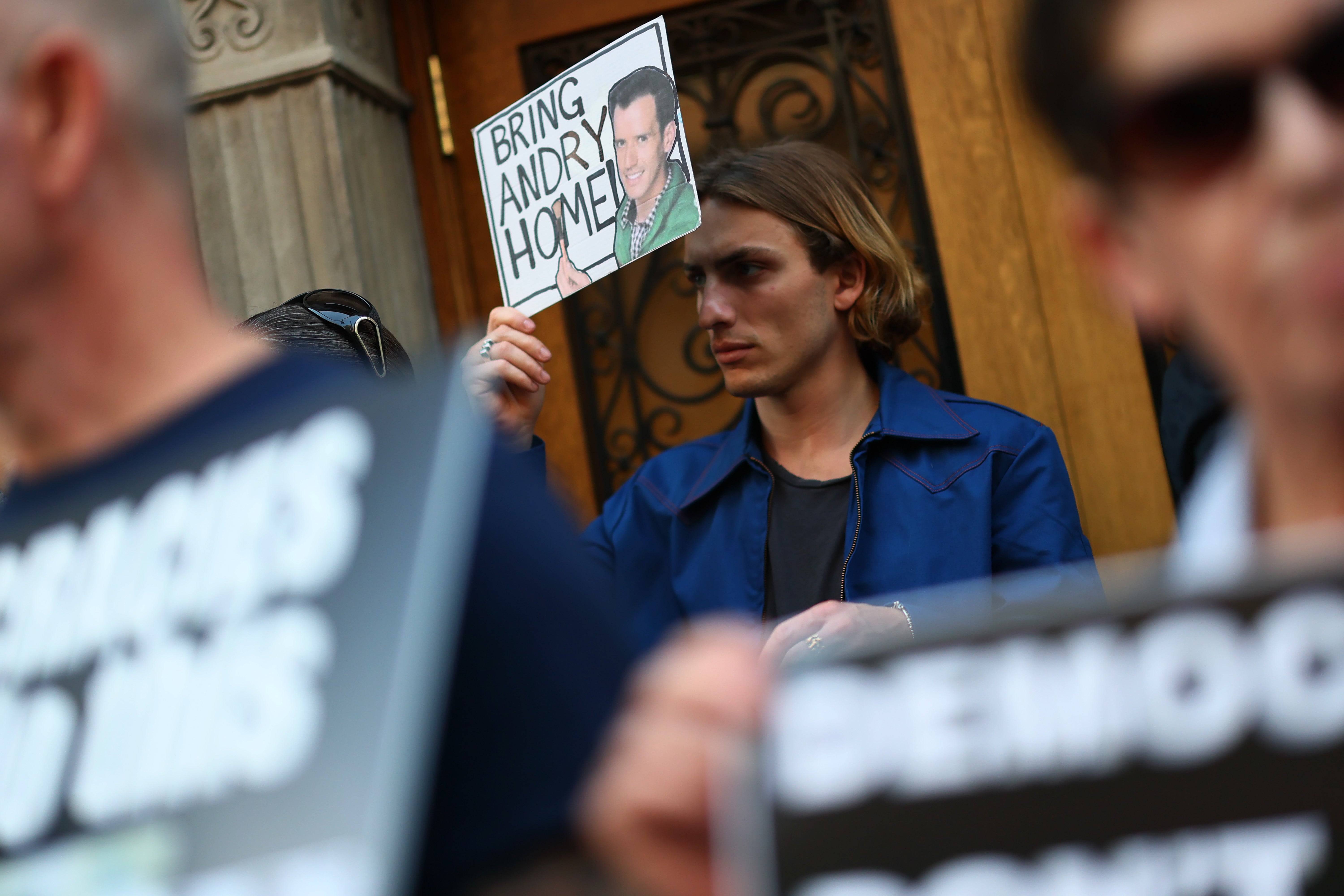 A protestor holds a photo of Hernandez Romero during a demonstration outside the Permanent Mission of El Salvador to the United Nations in New York on April 24