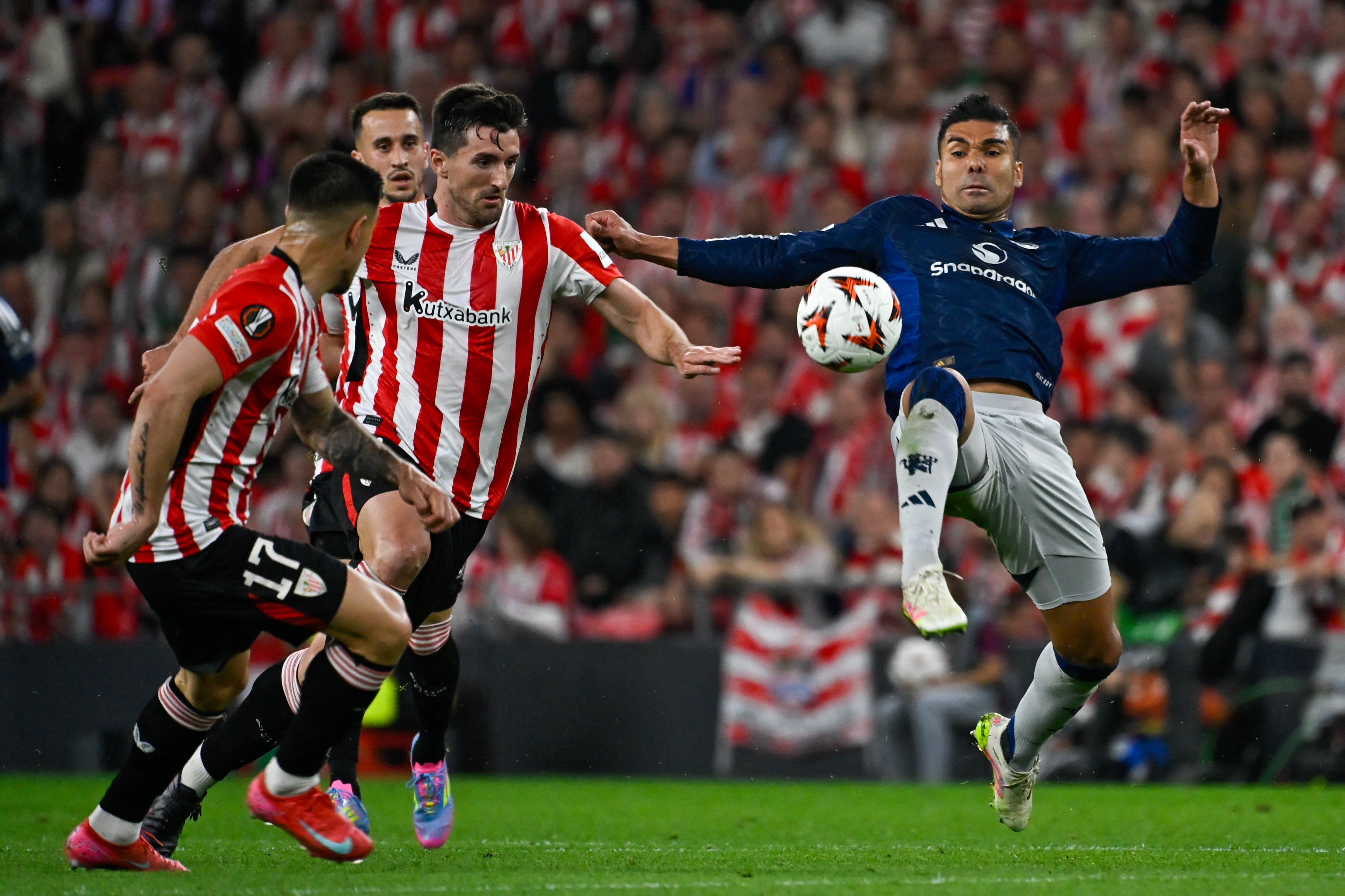 Casemiro challenges for the ball in midfield