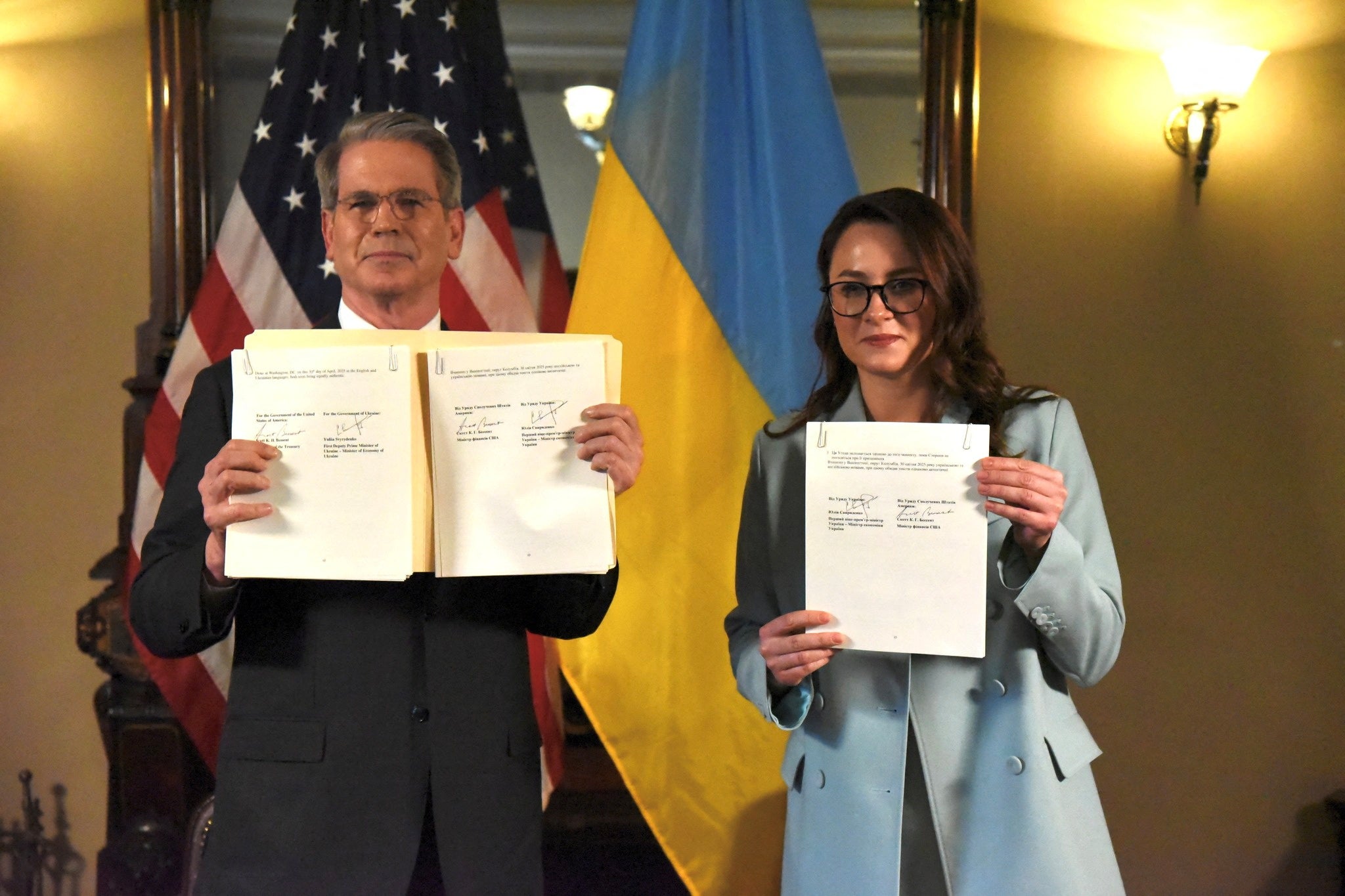US. Treasury Secretary Scott Bessent and Ukrainian First Deputy Prime Minister Yulia Svyrydenko pose after signing the deal