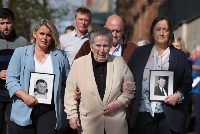Supporters of the family of GAA official Sean Brown, with widow Bridie Brown (centre), daughter Siobhan Brown (right), daughter Clare Loughran (left) arrive at Belfast’s Court of Appeal (Liam McBurney/PA)