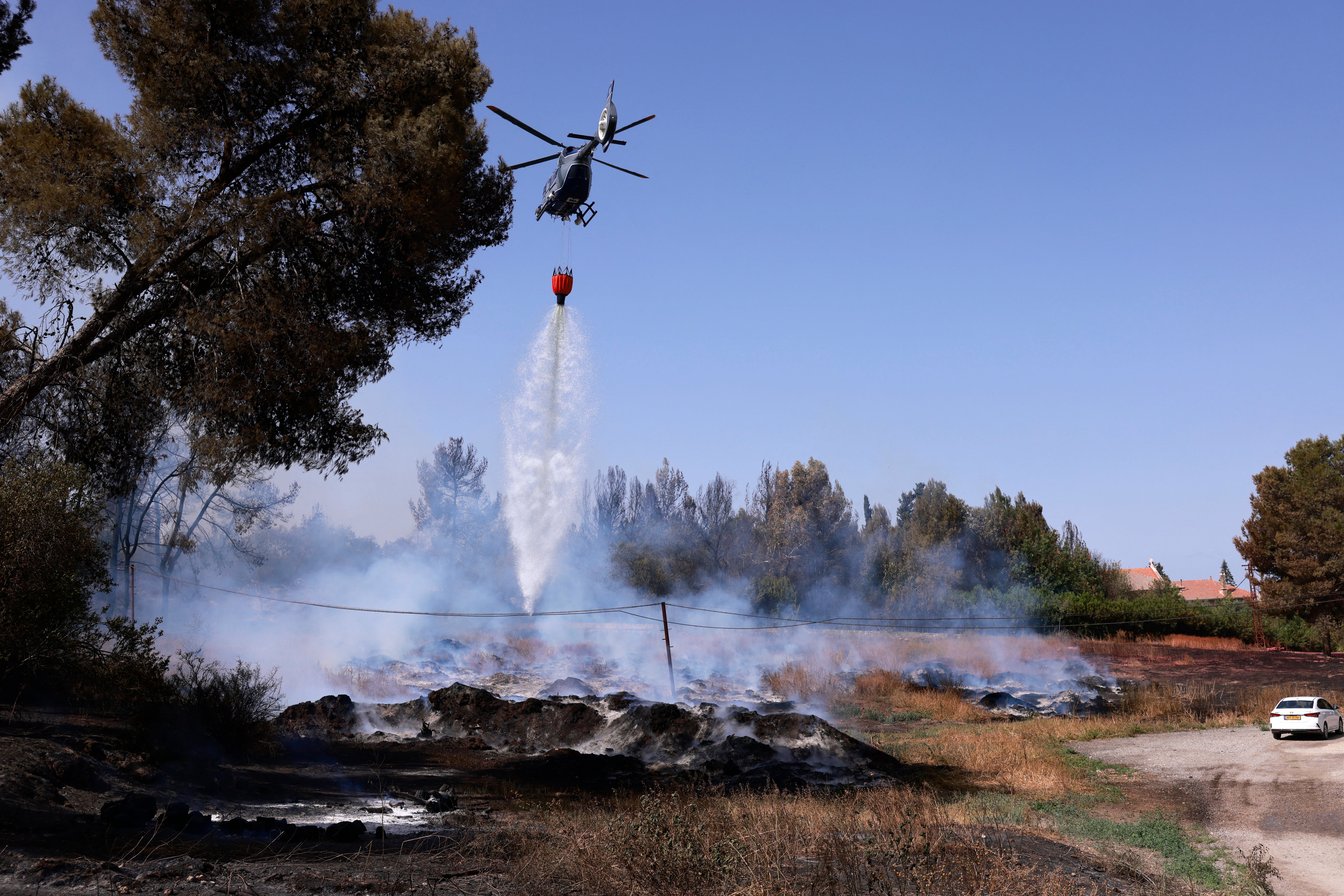 A firefighting aircraft dousing a fire with retardant in the Latrun area, in central Israel