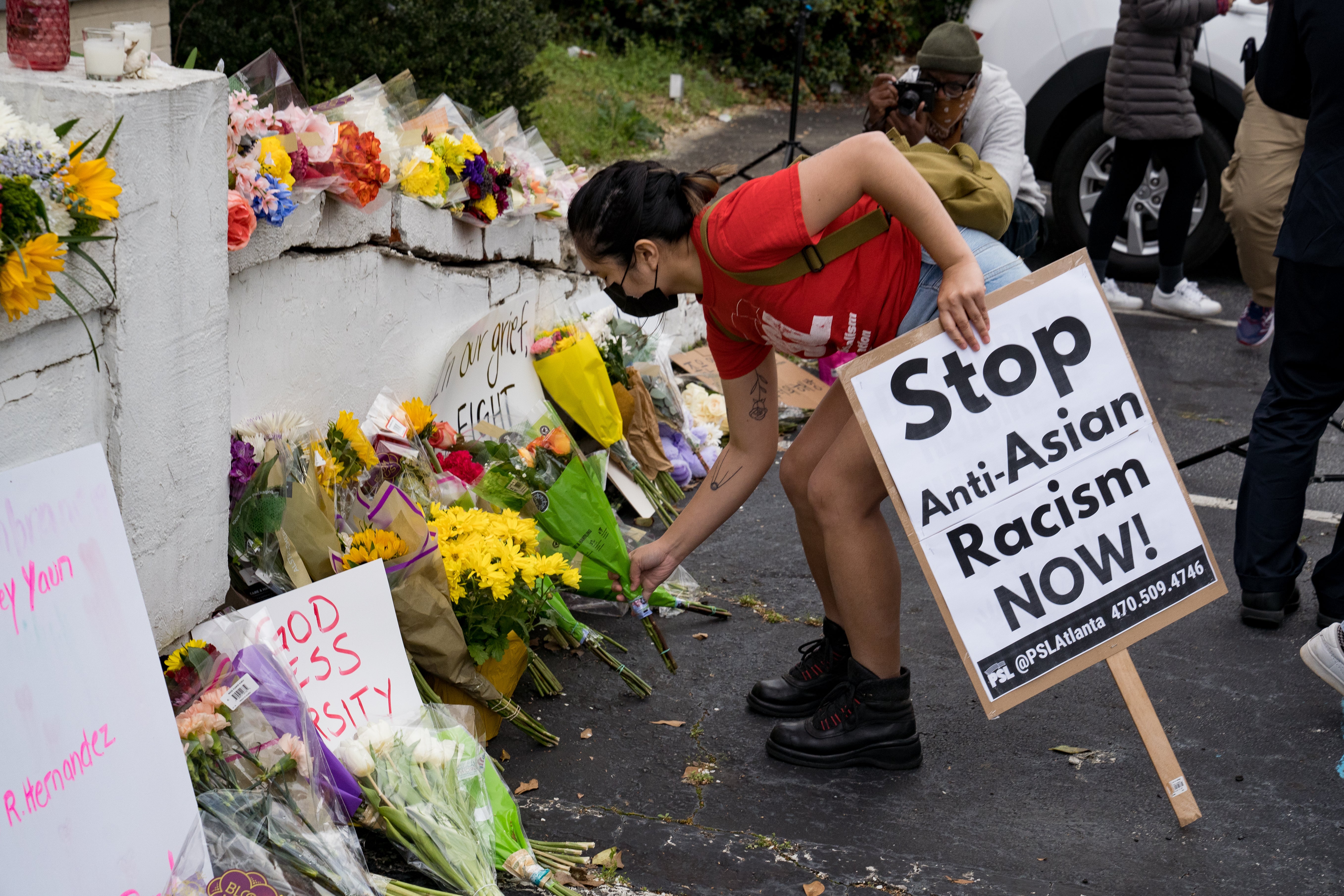 Activists drop flowers during a demonstration against violence against women and Asians on March 18, 2021, in Atlanta, Georgia. More than half of all Asian Americans say that it’s at least somewhat likely that they will be subjected to discrimination in the next half-decade, according to a new poll