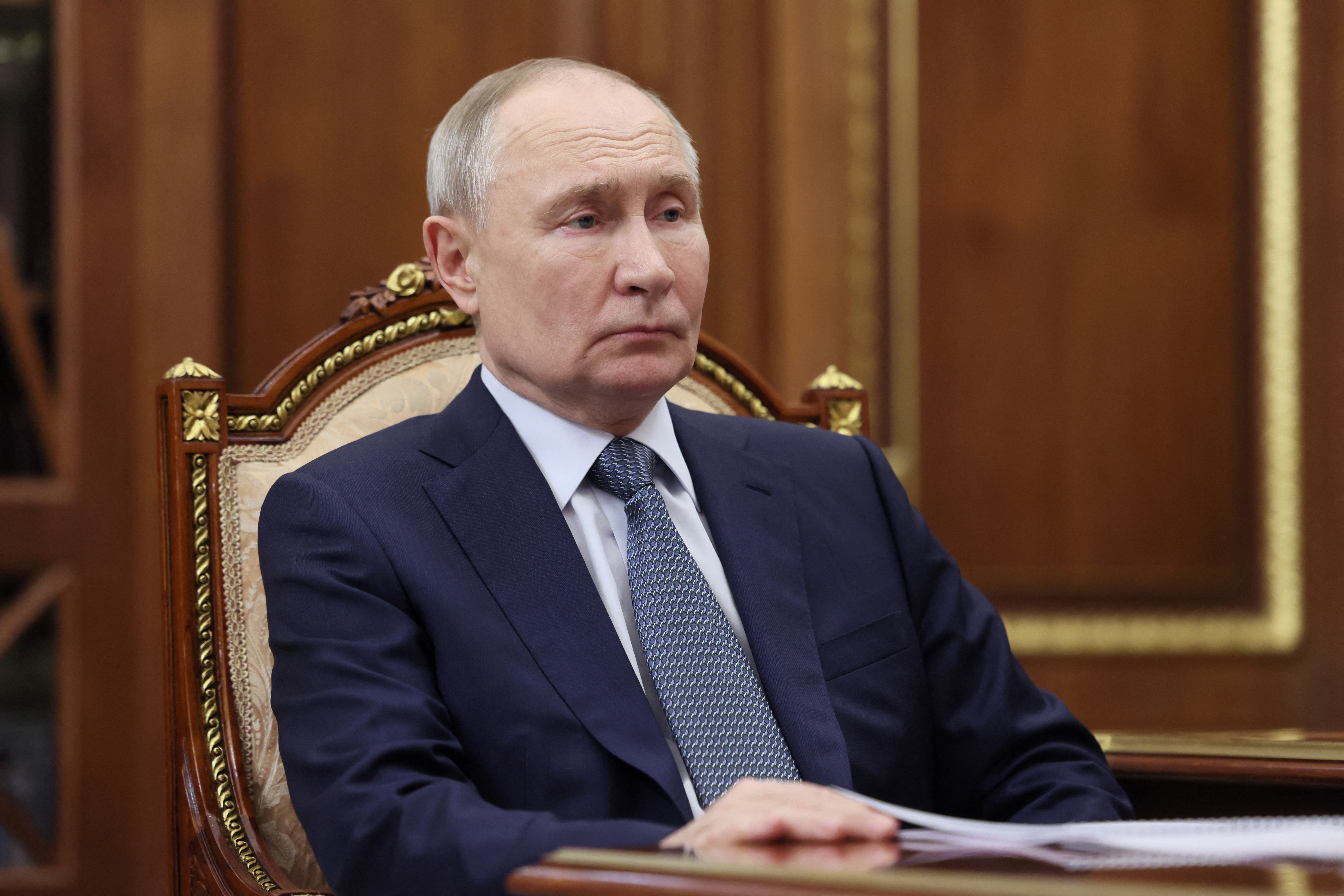 Russia's president Vladimir Putin reacts as he meets with the governor of the Moscow region