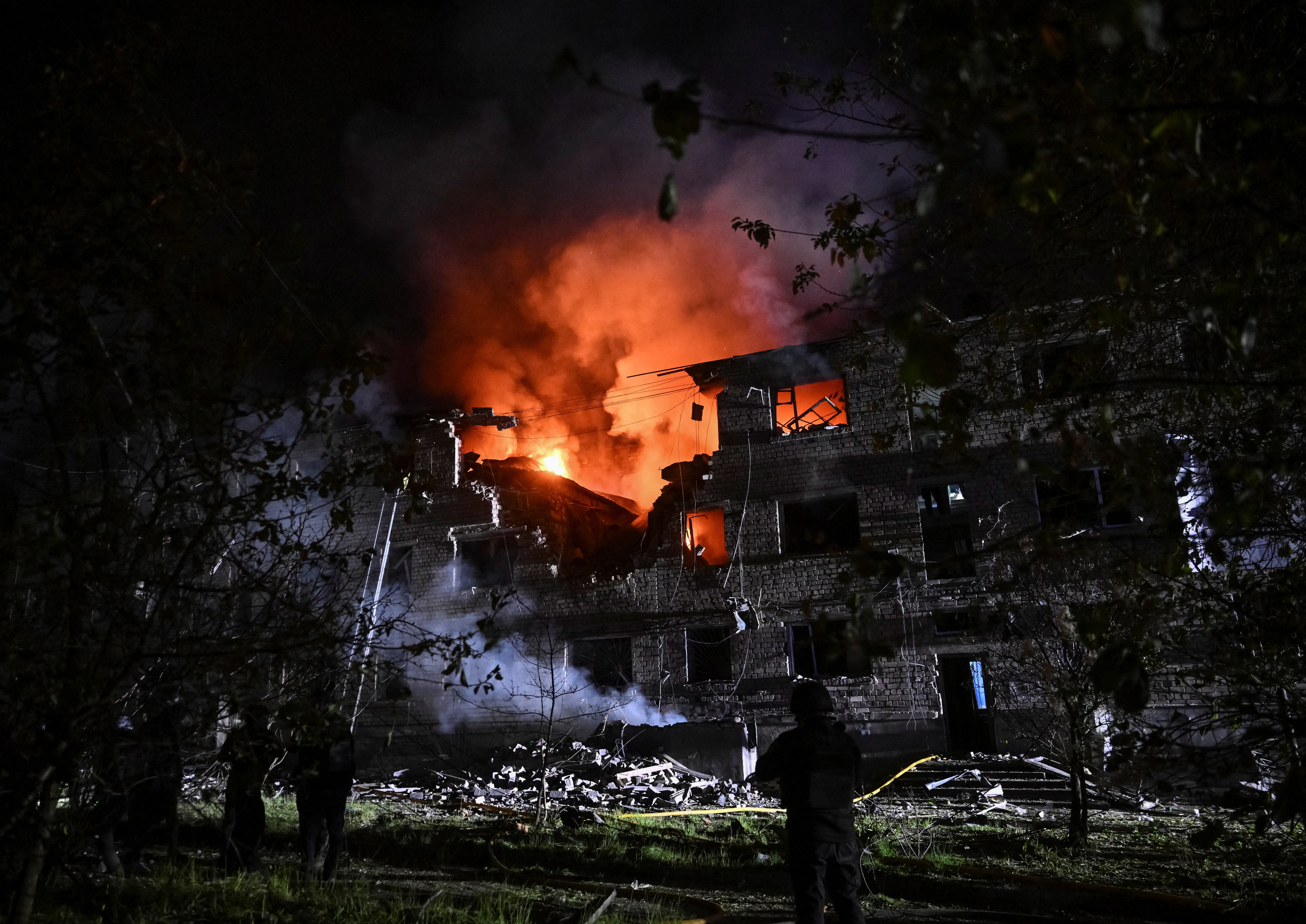 Rescuers work at a site of an apartment building hit by a Russian drone strike