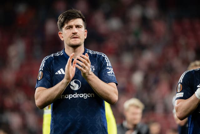 <p>Harry Maguire of Manchester United applauds the fans in Bilbao</p>