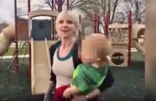 <p>Mom at playground in Rochester, Minnesota, with her own child on her hip, laughs off complaints from a parent after she called a little boy a racial slur</p>