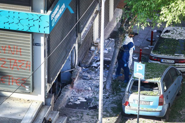 <p>Greek police forensic experts search the area where a 38-year-old woman was killed early on Saturday</p>