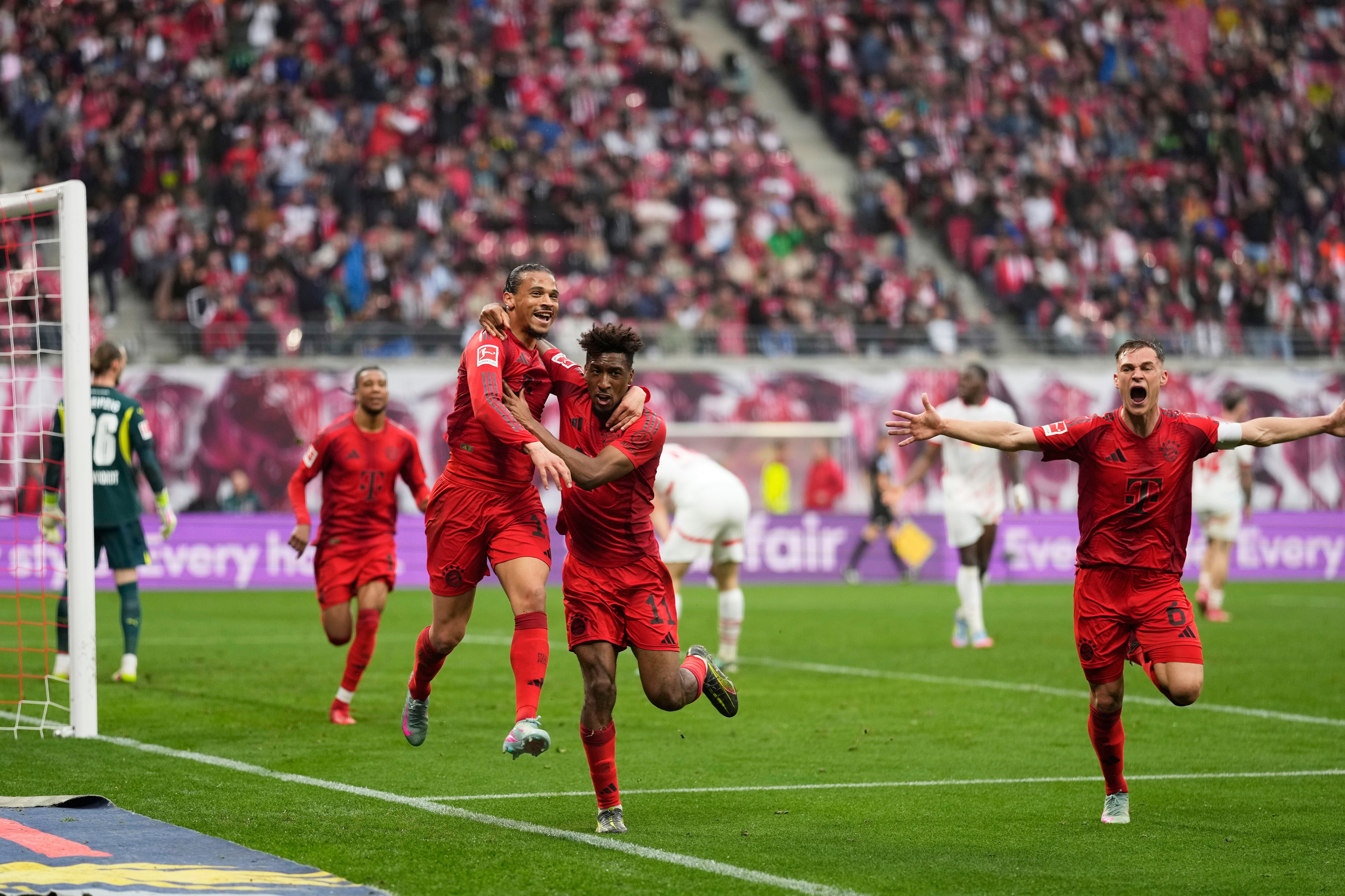 Bayern's Leroy Sane, left, celebrates with Kingsley Coman after scoring his side's third goal