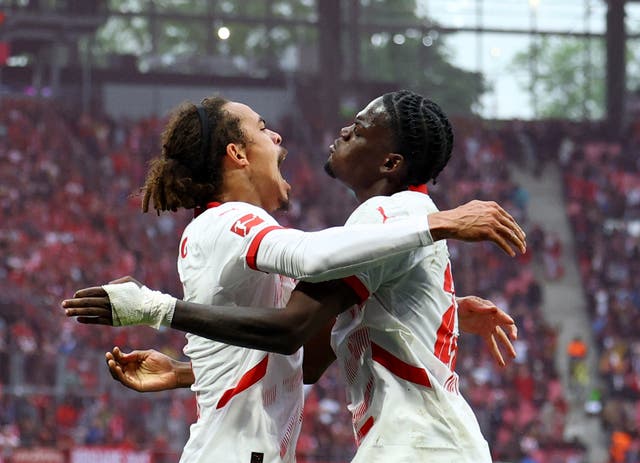 <p>RB Leipzig’s Yussuf Poulsen celebrates scoring their third goal with Castello Lukeba</p>
