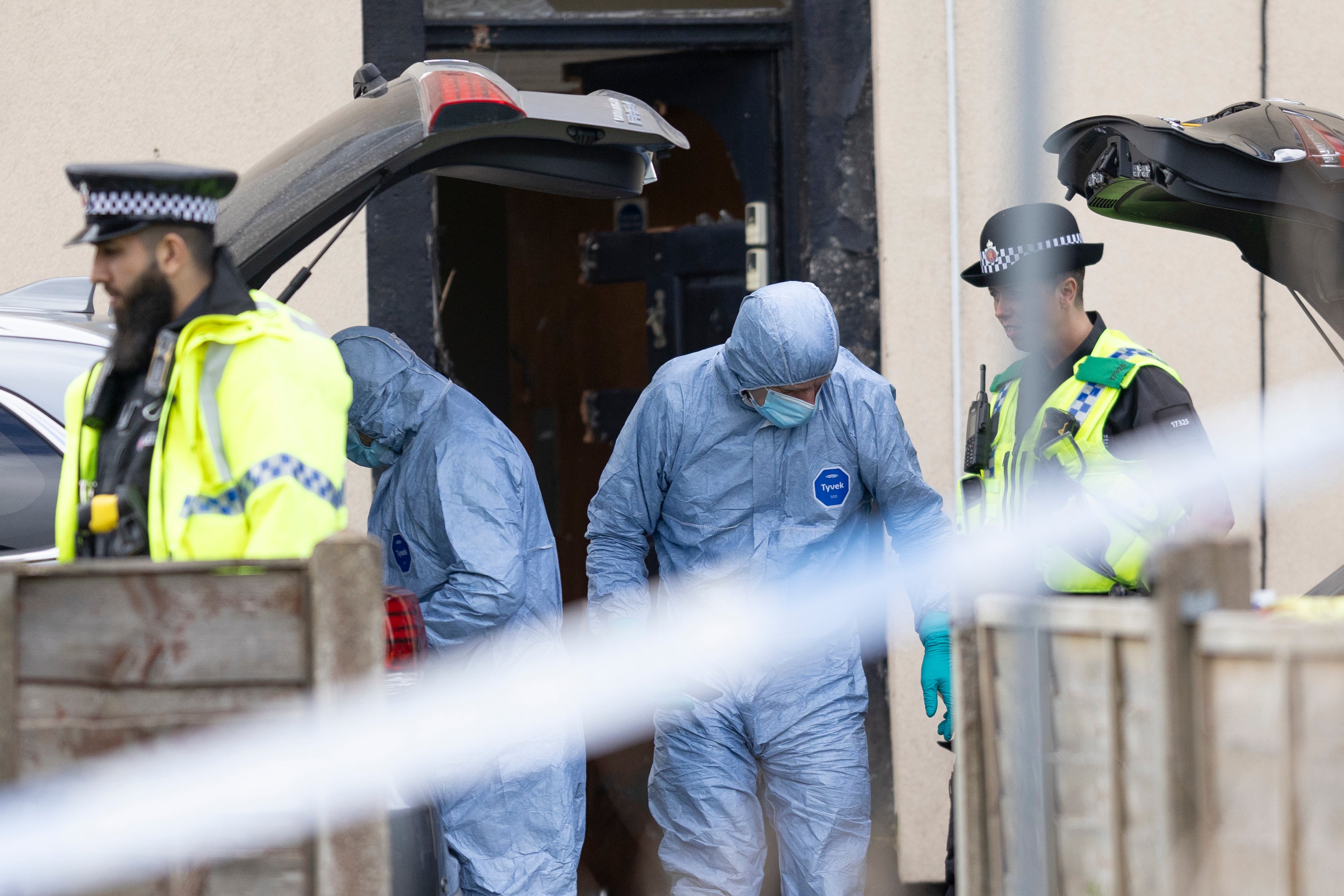 Police forensic officers search a house on in Rochdale on Sunday