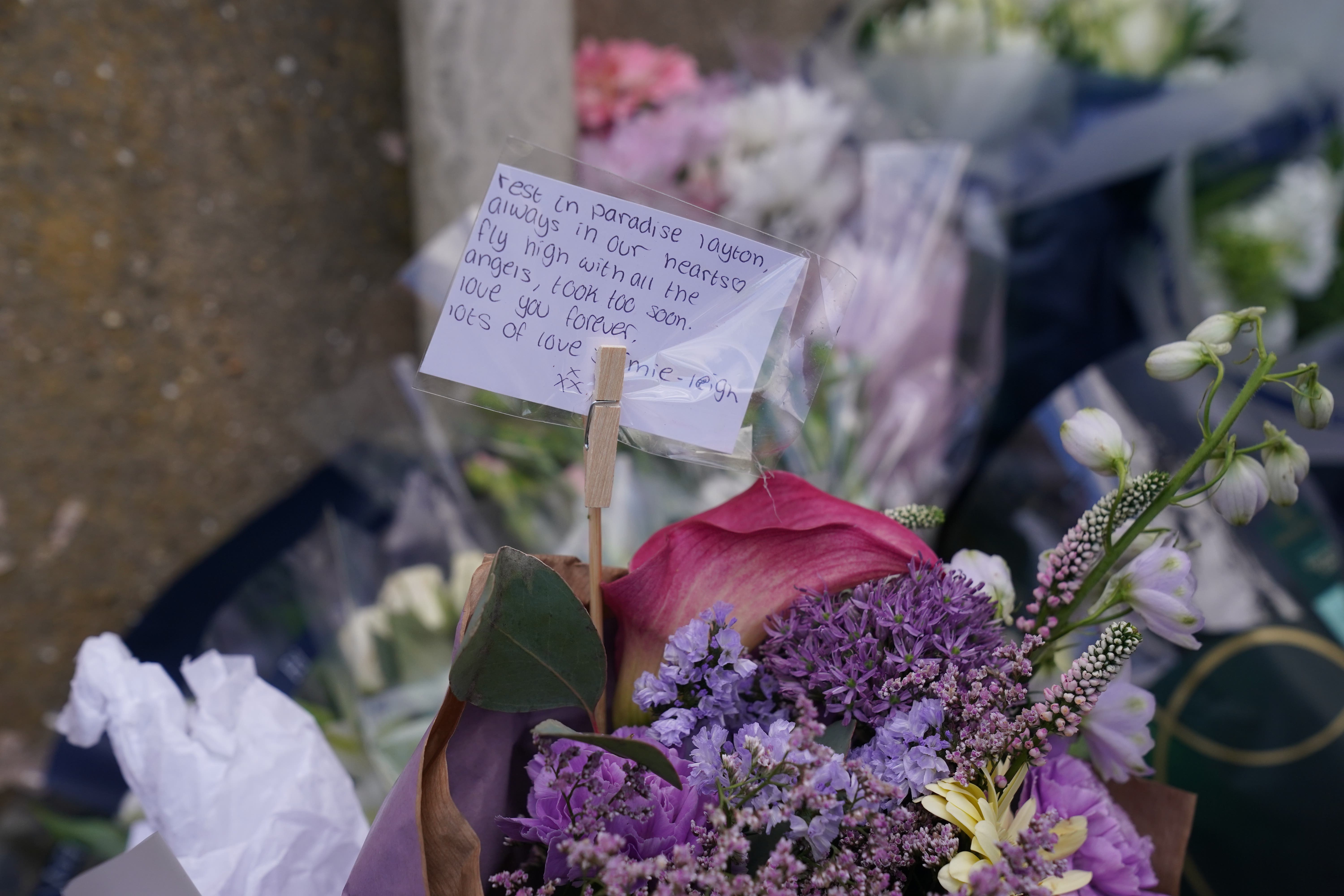 Floral tributes left by the gates of Fairfield Industrial Park in the Bill Quay area of Gateshead where a body believed to be that of 14-year-old Layton Carr was located deceased inside a building following a fire