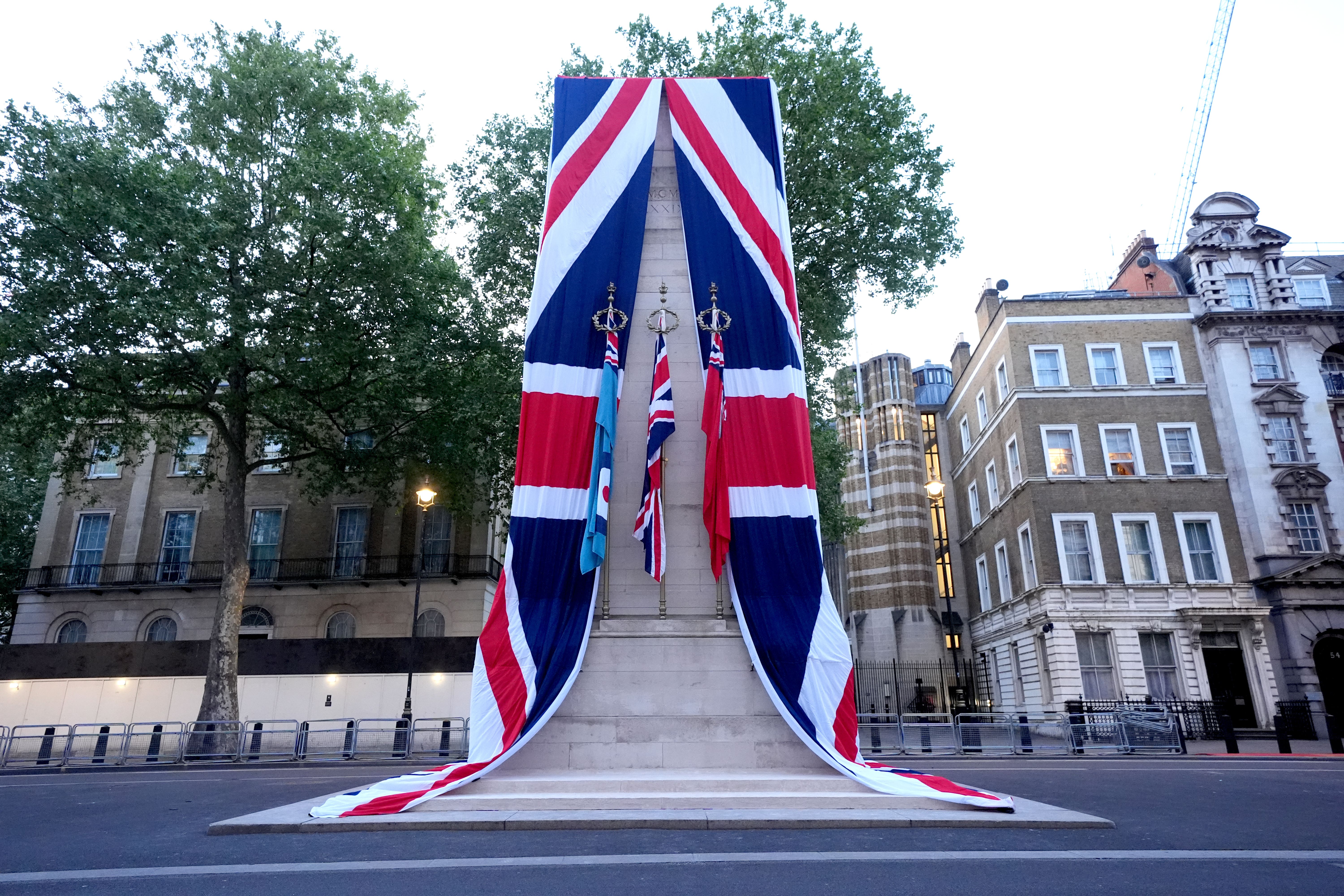 The Cenotaph on Whitehall is dressed in the Union flag ahead of a military procession (Lucy North/PA)