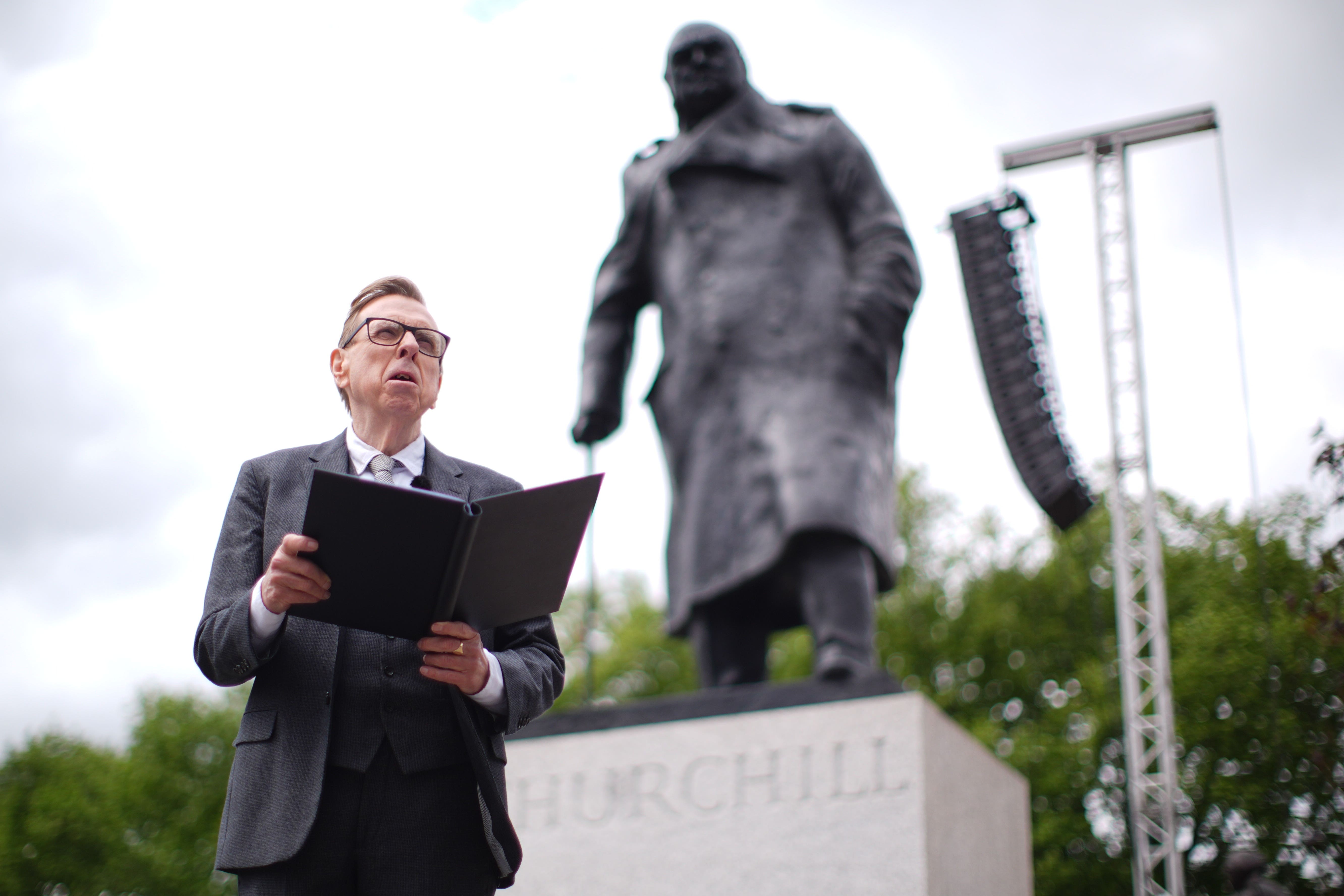 Actor Timothy Spall performs his reading of Sir Winston Churchill’s 1945 victory speech in front of a statue of the war time leader (James Manning/PA).