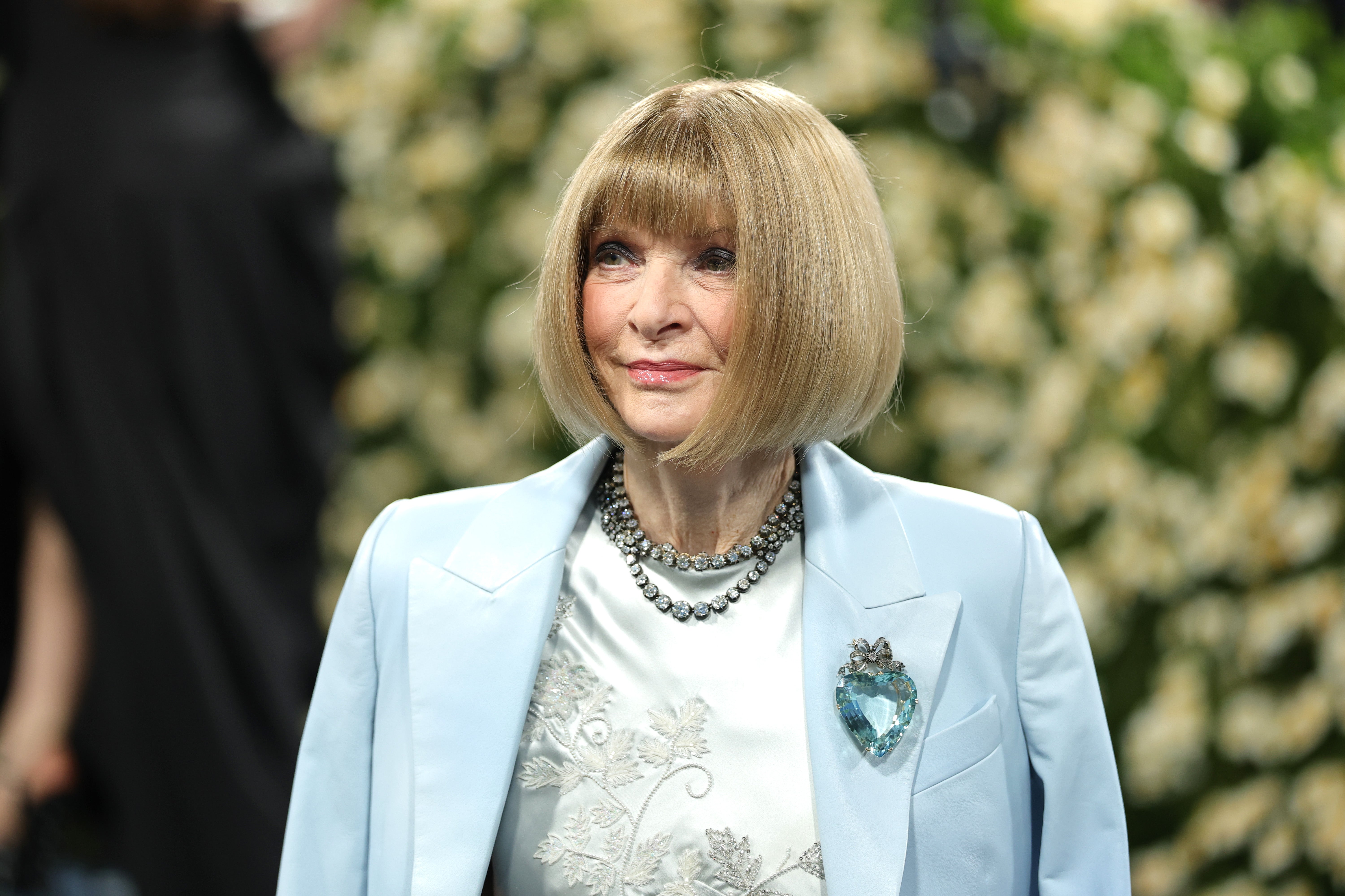 Wintour, a co-chair for the annual event, embellished her look with a strawberry-shaped glass brooch and a layered diamond necklace