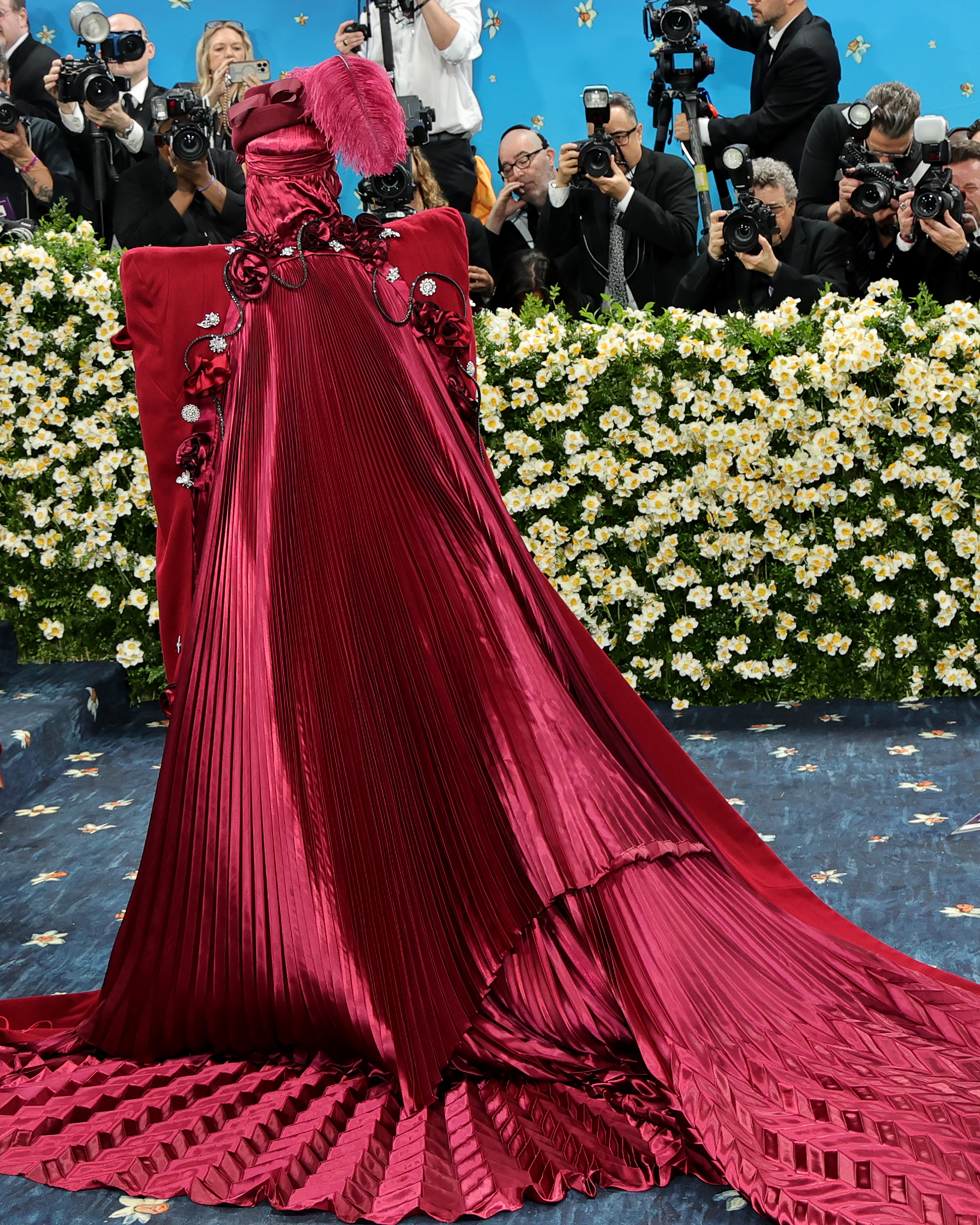 The full look was adorned with intricate accessories, including multiple silver waist chains, a cane, brooches, fiery red gloves, and platform Marc Jacobs heels