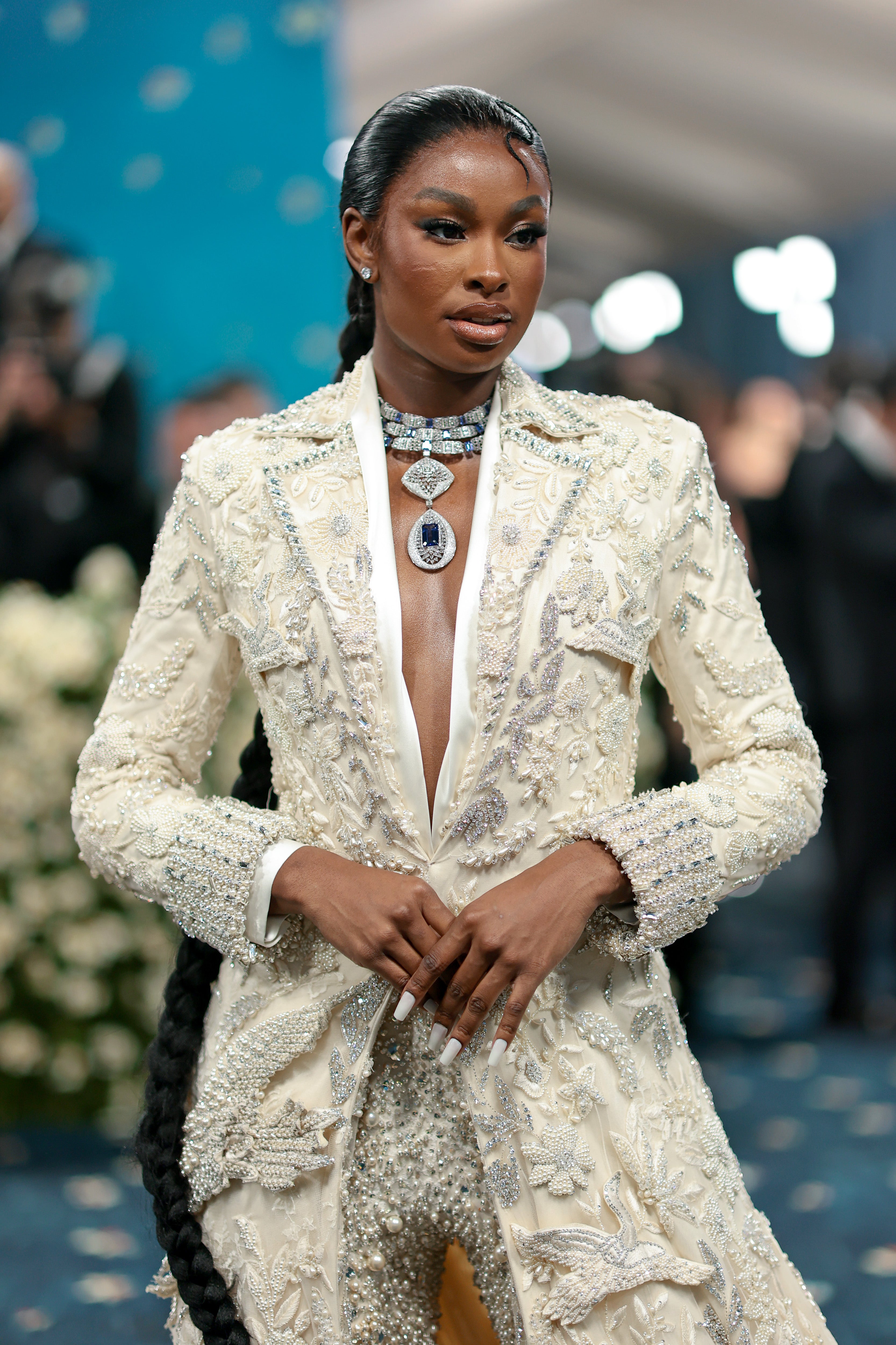 Coco Jones arrived in a cream floor-length jacket, adorned with silver embroideries. She also wore matching pants adorned with jewels and a silver statement necklace