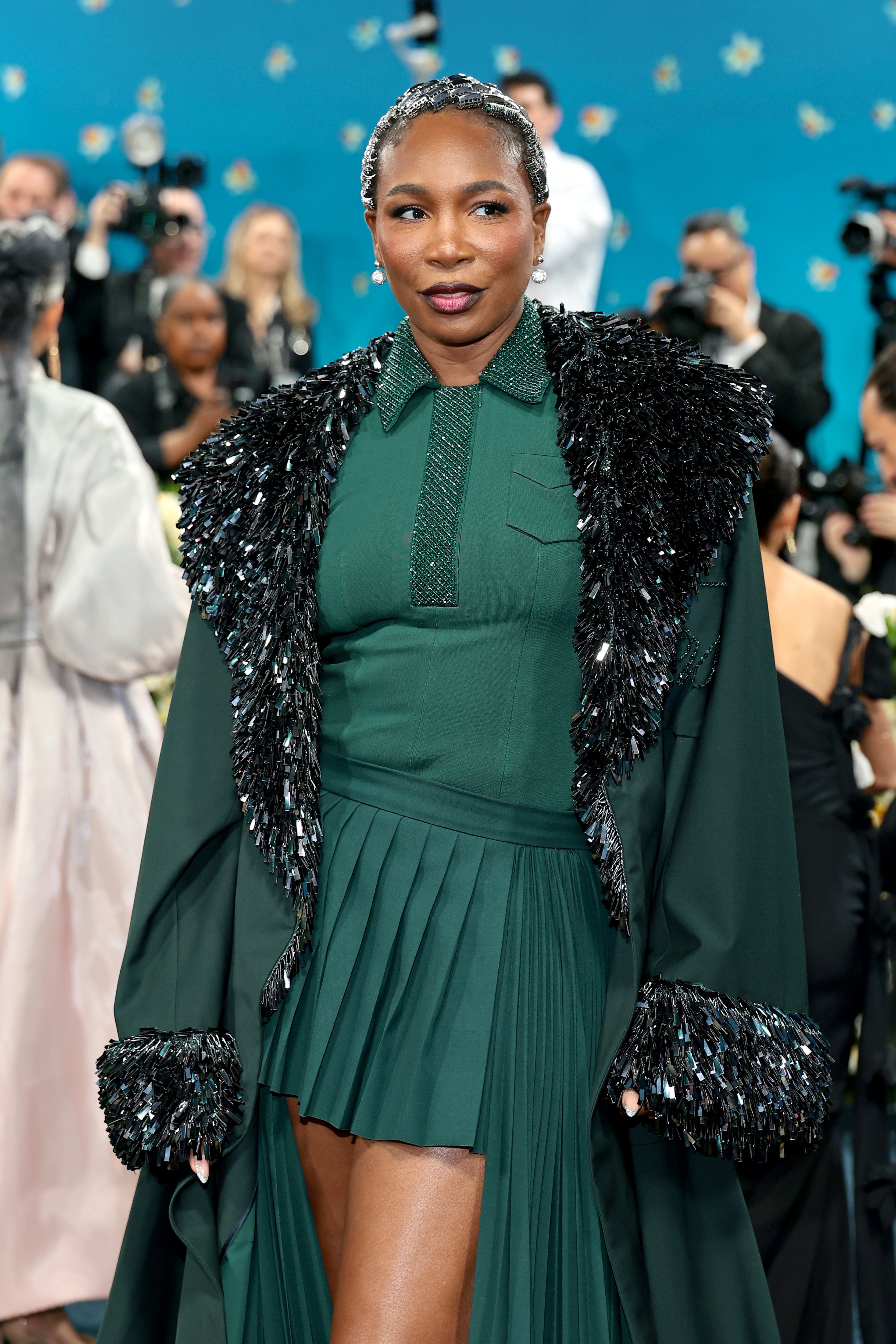 The 44-year-old athlete drew inspiration from the sport while juxtaposing a uniform silhouette with a long overcoat that seemed more suitable for the holiday season