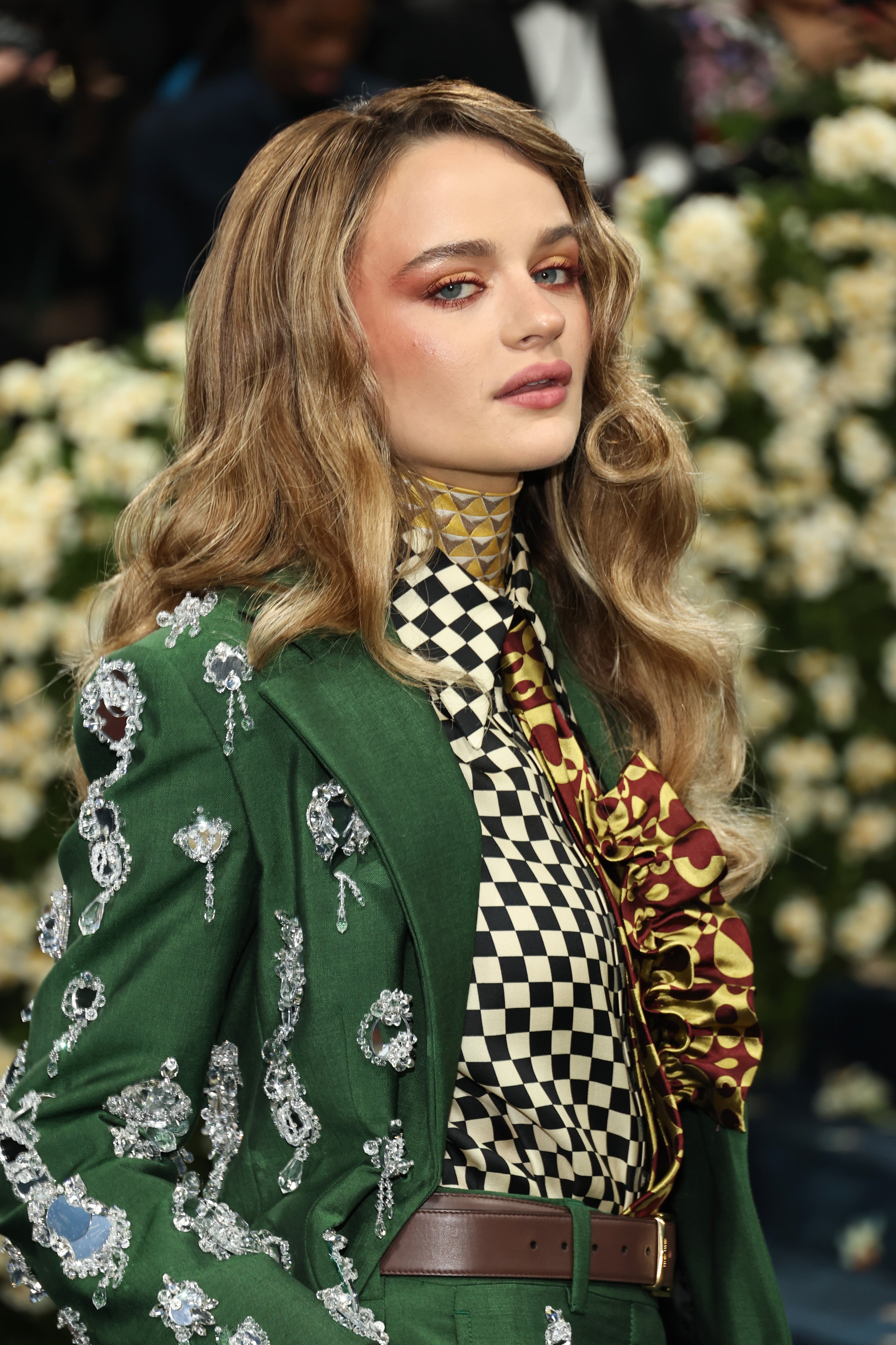 The ‘Kissing Booth’ star’s outfit mixed too many patterns between her checkered blouse, maroon and gold tie, diamond neck scarf, and a random brown belt