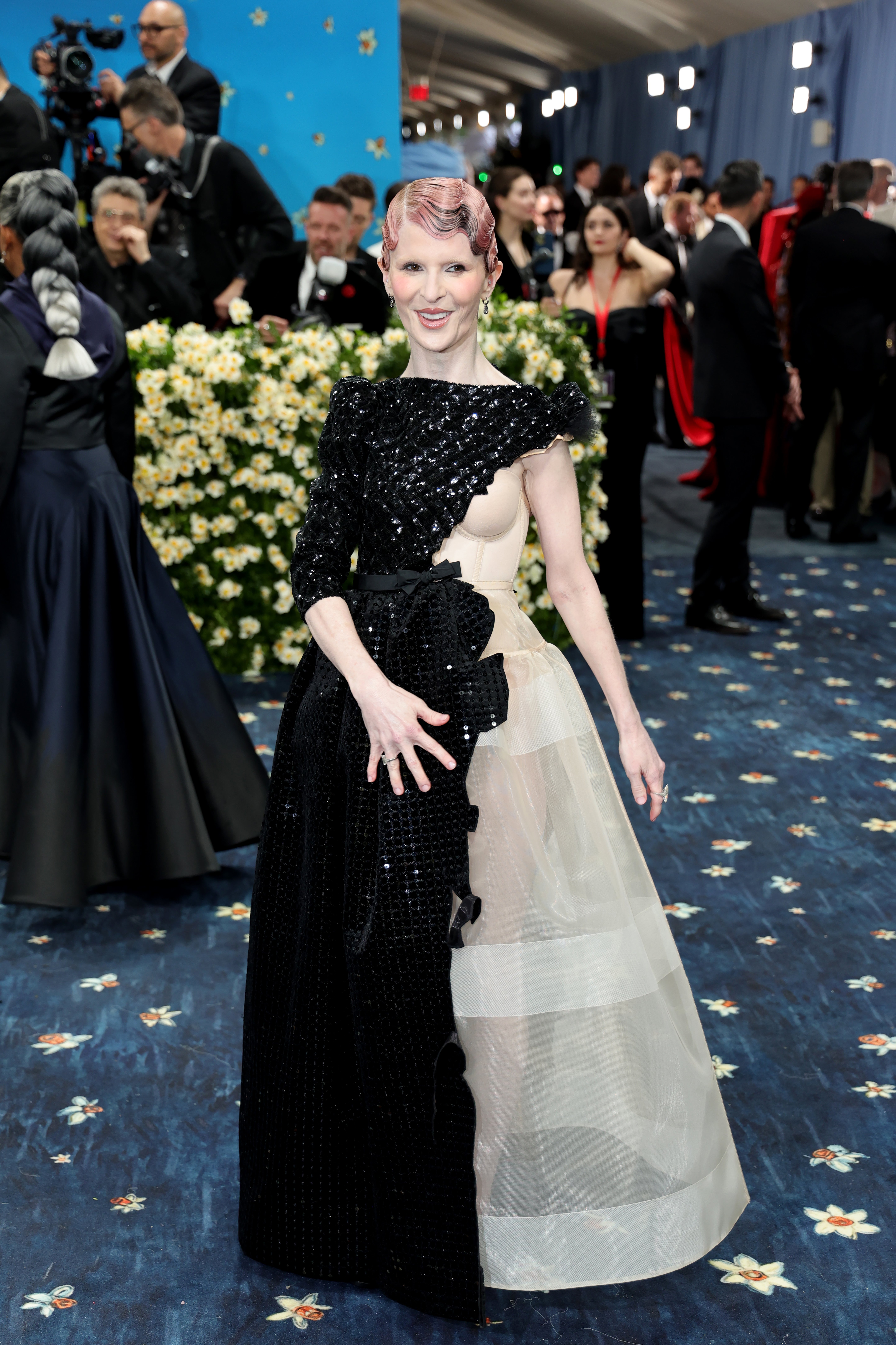 Fashion architect Lauren Amos arrived outside the Met in a deconstructed, one-shoulder gown that was spliced with sheer and black sparkly embroidery