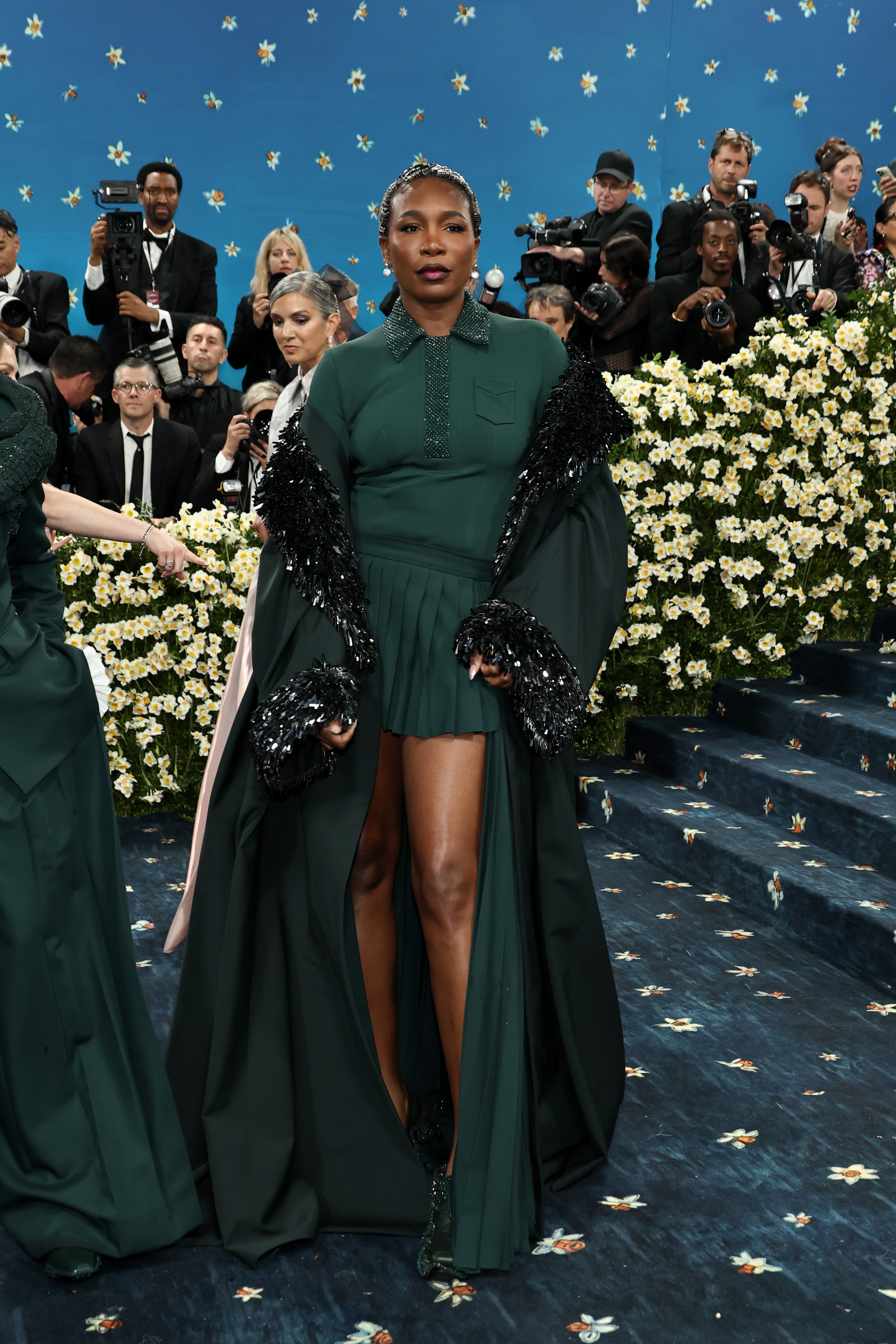 Venus Williams posed for the cameras on the Met steps in a forest green collared shirt and skirt set that was reminiscent of her tennis attire