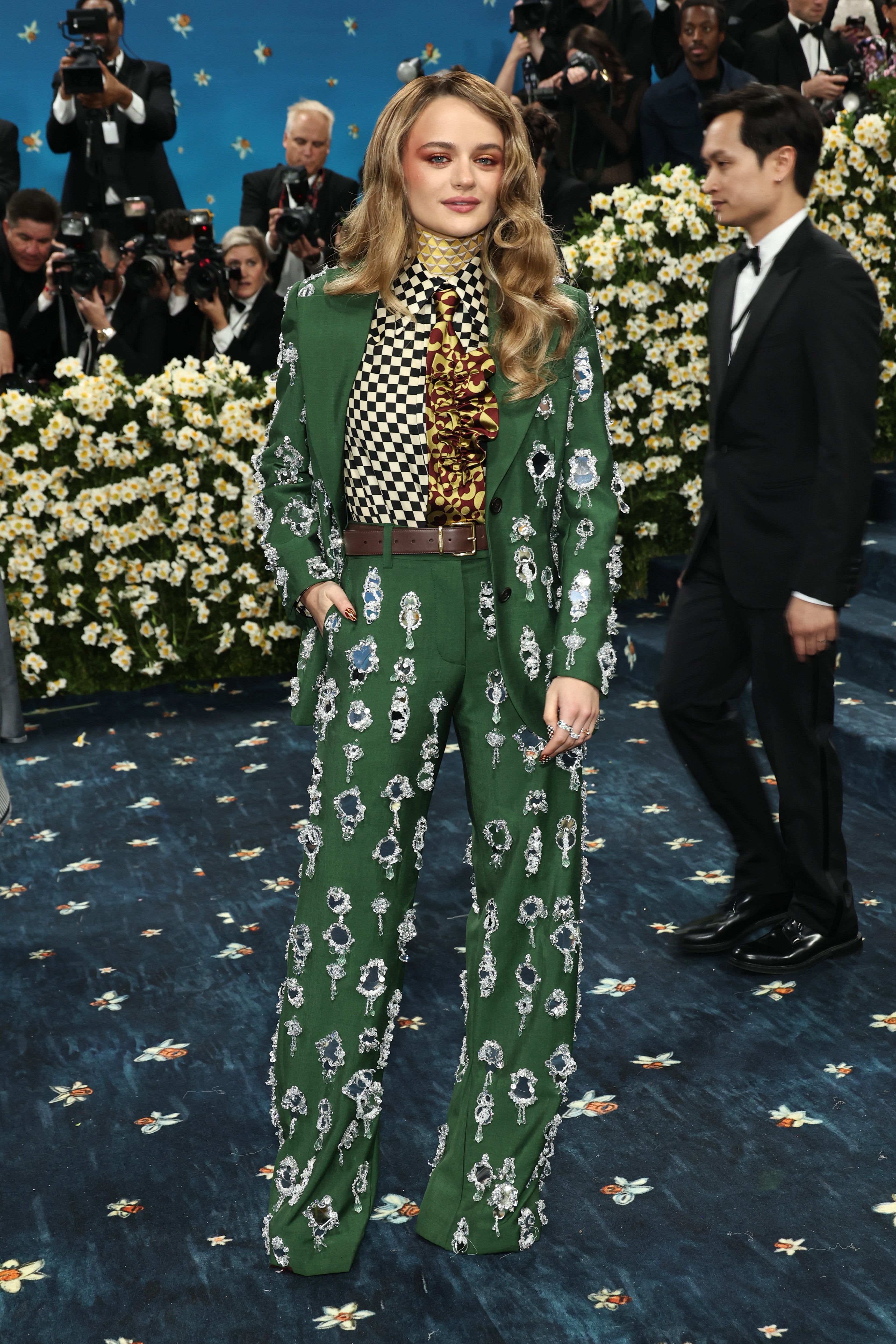 Joey King suited up for the 2025 Met Gala in a matching green Miu Miu jacket and pants with crystals dripping and dangling down