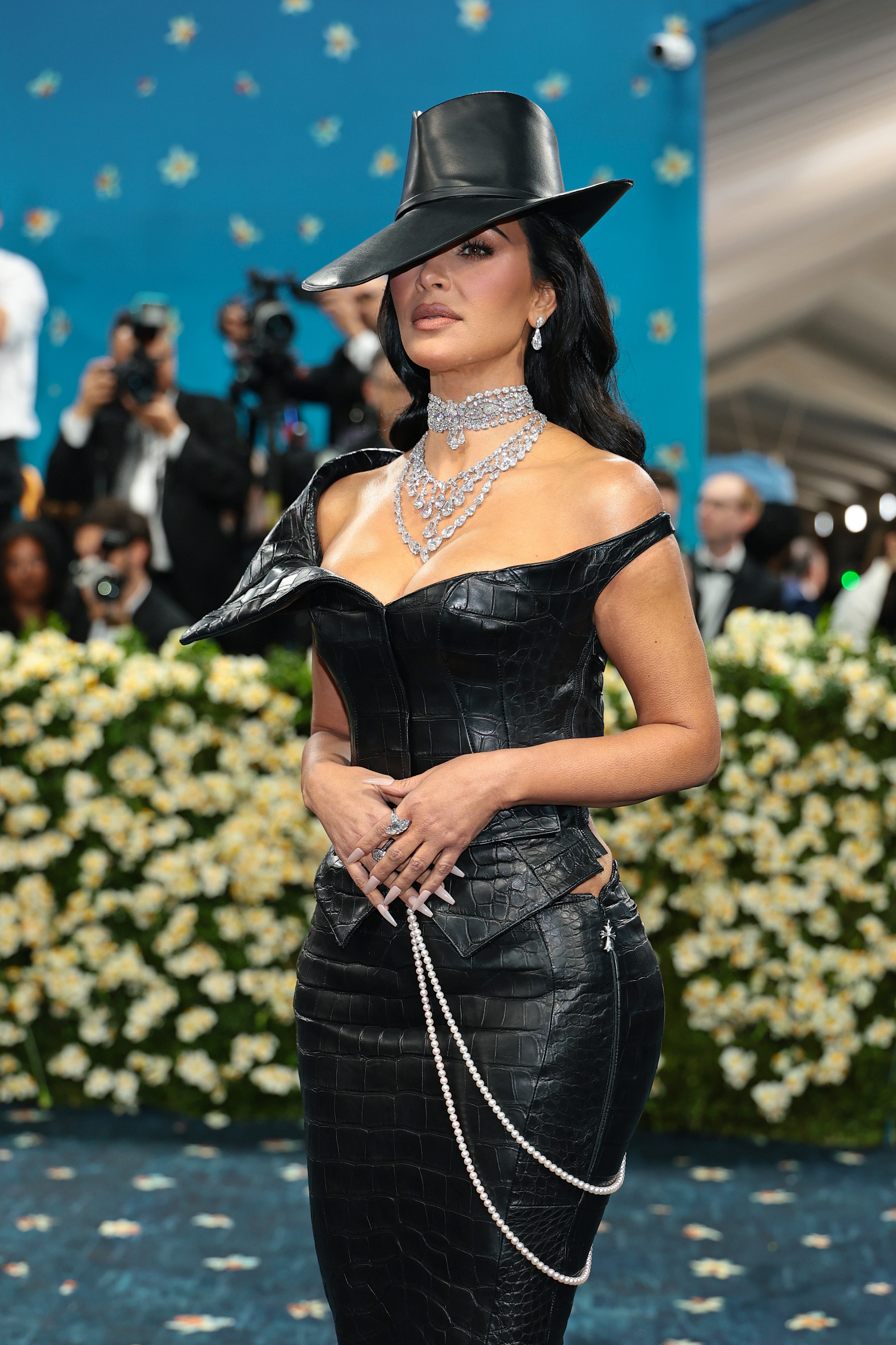 The Skims founder kept her glam under the cover of a statement brim hat