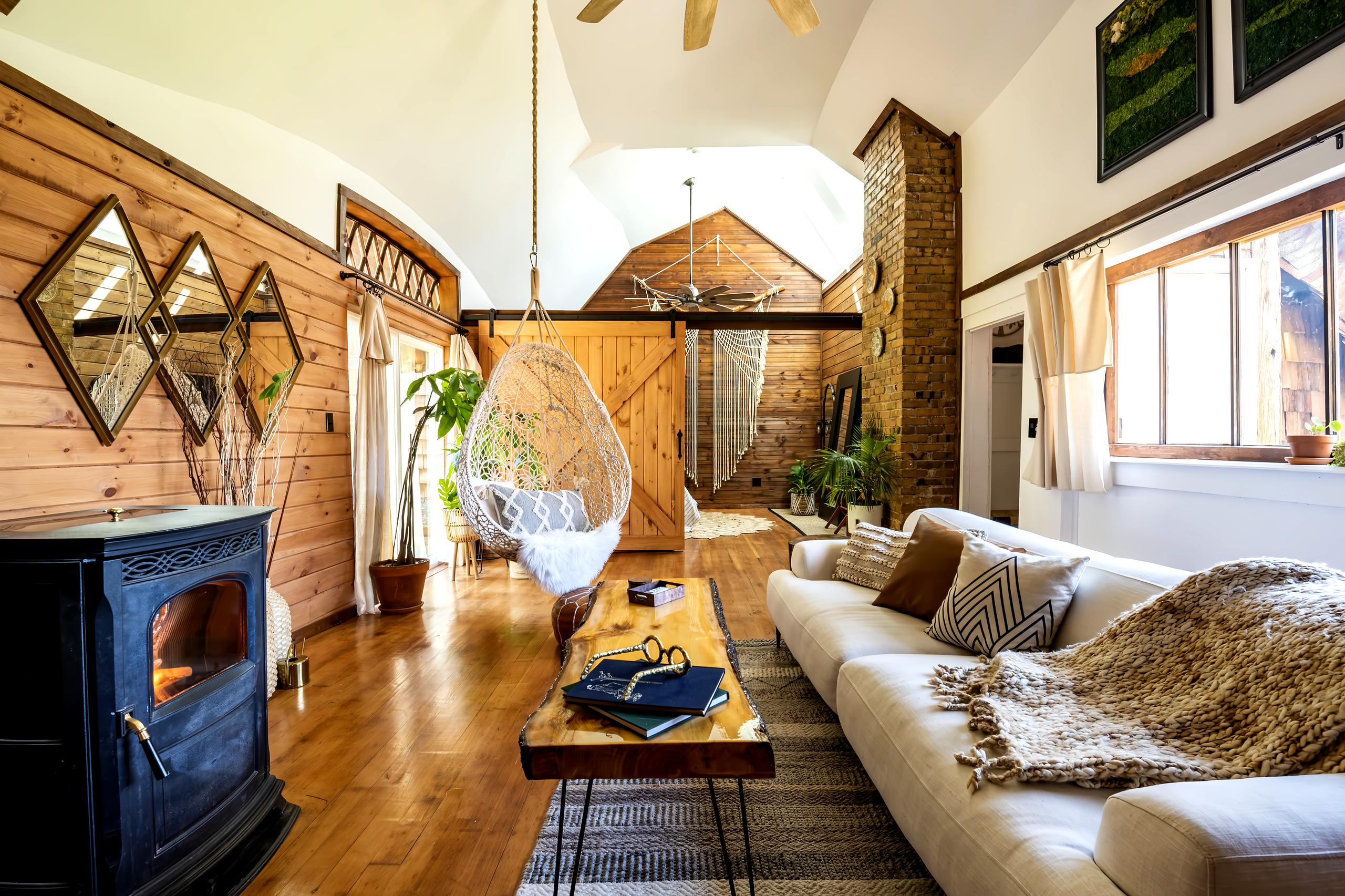 Features include a huge sofa, a hanging chair and garden views