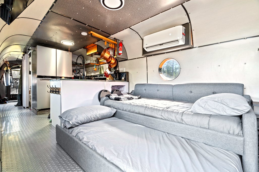 A kitchen, bath and living area have been custom-designed for the space