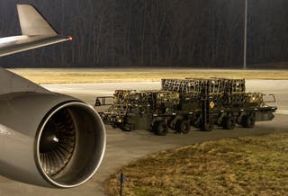 A 436th Aerial Port Squadron ramp services Airman stages a cargo loader with palletised ammunition, weapons and other equipment bound for Ukraine during a foreign military sales mission at Dover Air Force Base in Delaware