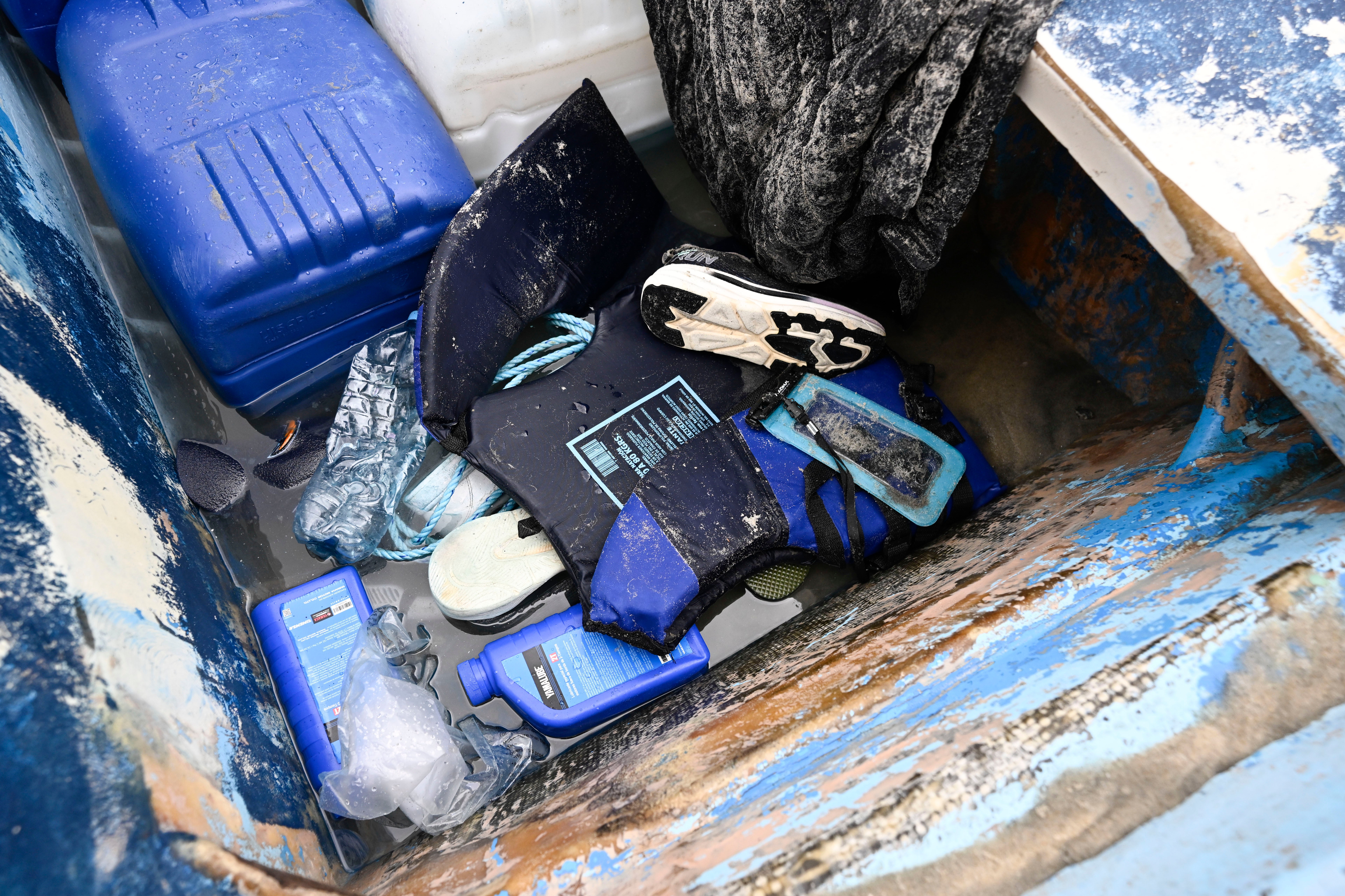 Life jackets and personal items are seen in a boat that capsized Monday