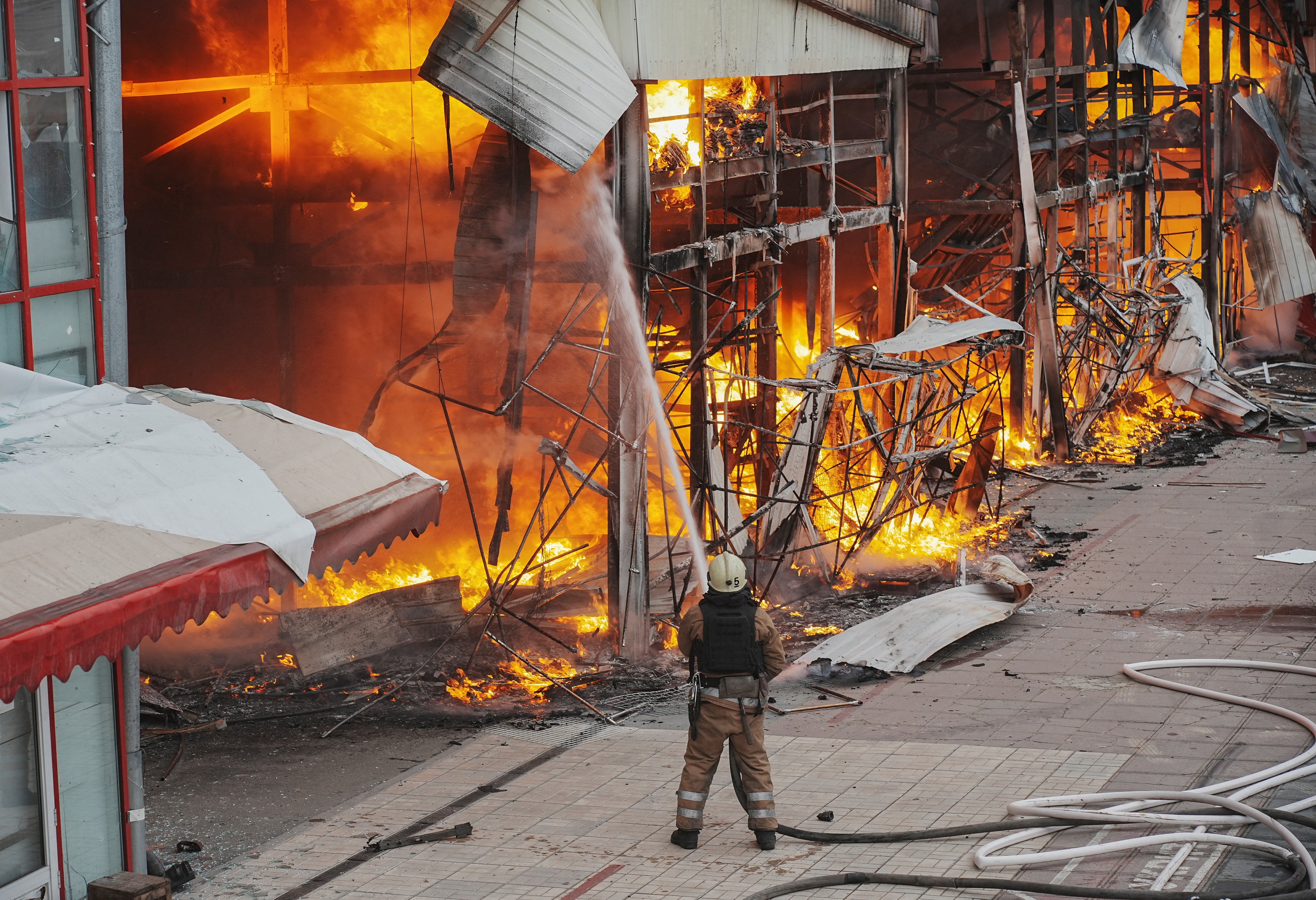 A firefighter works at the site of the Barabashovo market hit by a Russian drone strike