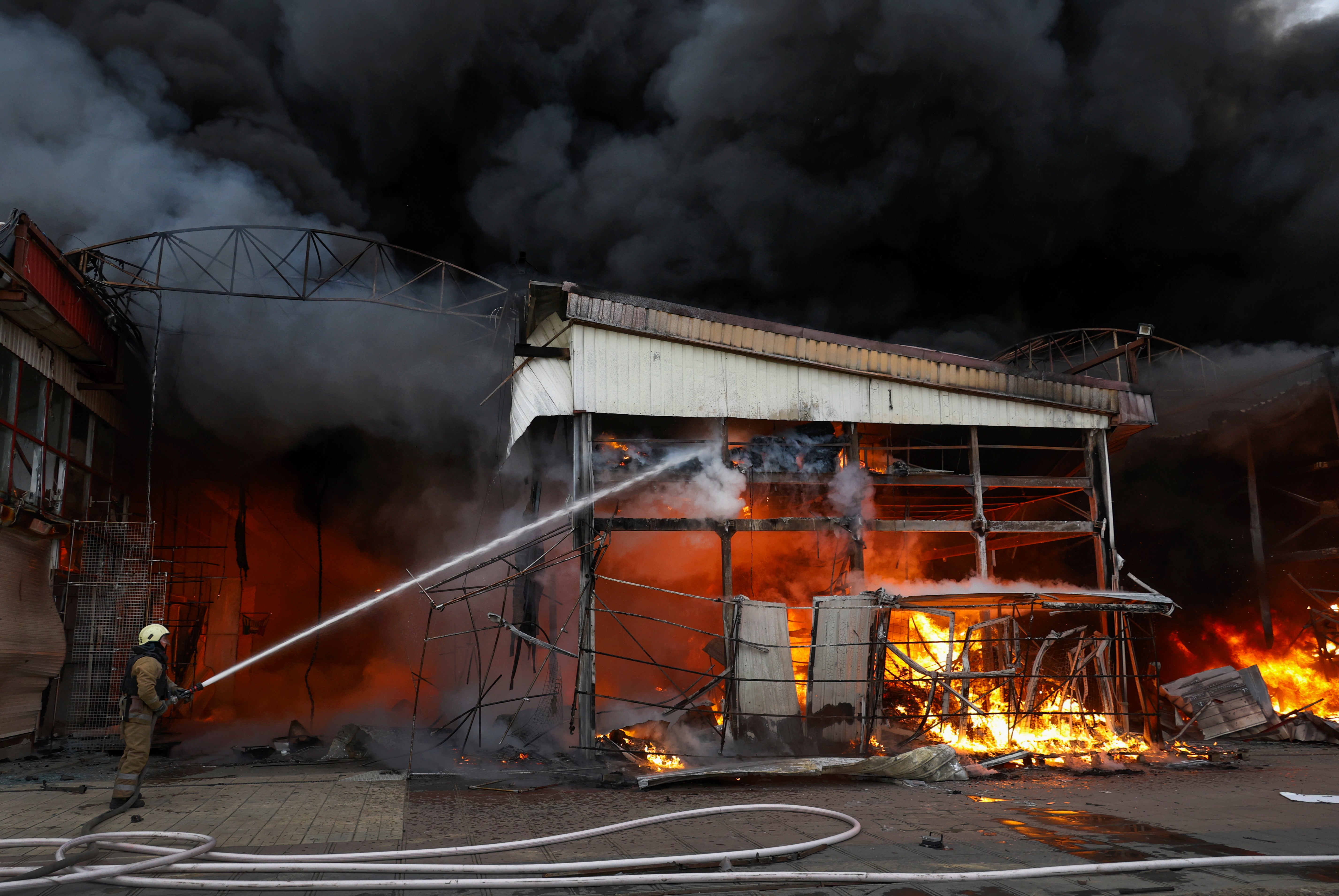 Emergency services battle a blaze at the site of a drone strike on the Barabashovo market
