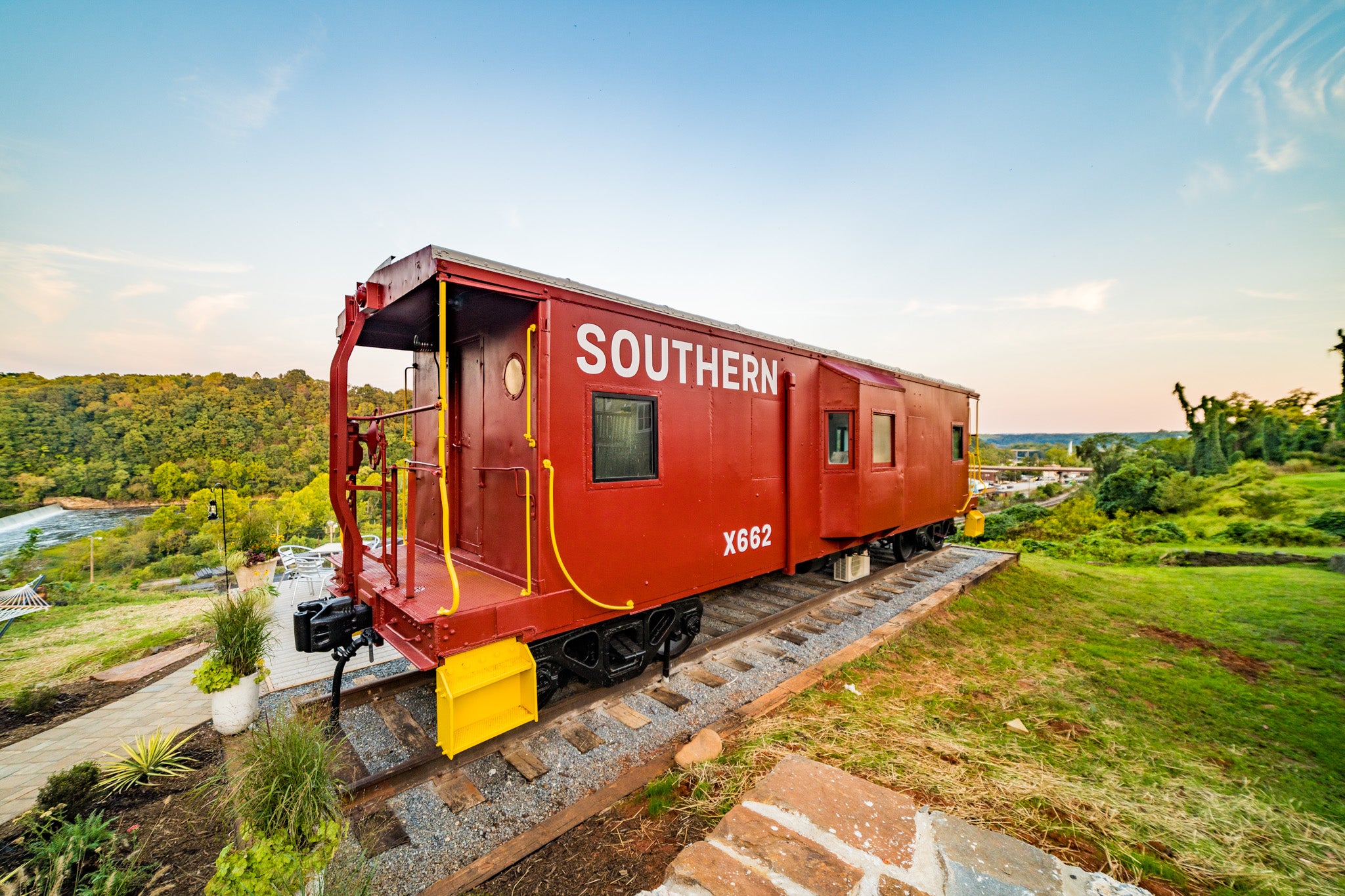 This caboose rental in Lynchburg sits above the James River and a railway line