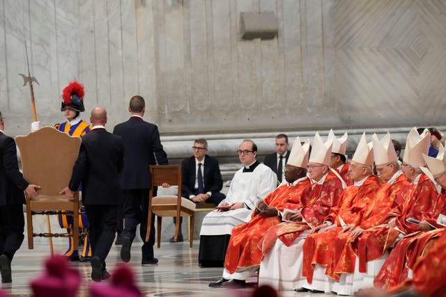 <p>A chair is taken away at the end of a final mass celebrated by cardinals inside St Peter’s Basilica, before the conclave to elect a new pope </p>